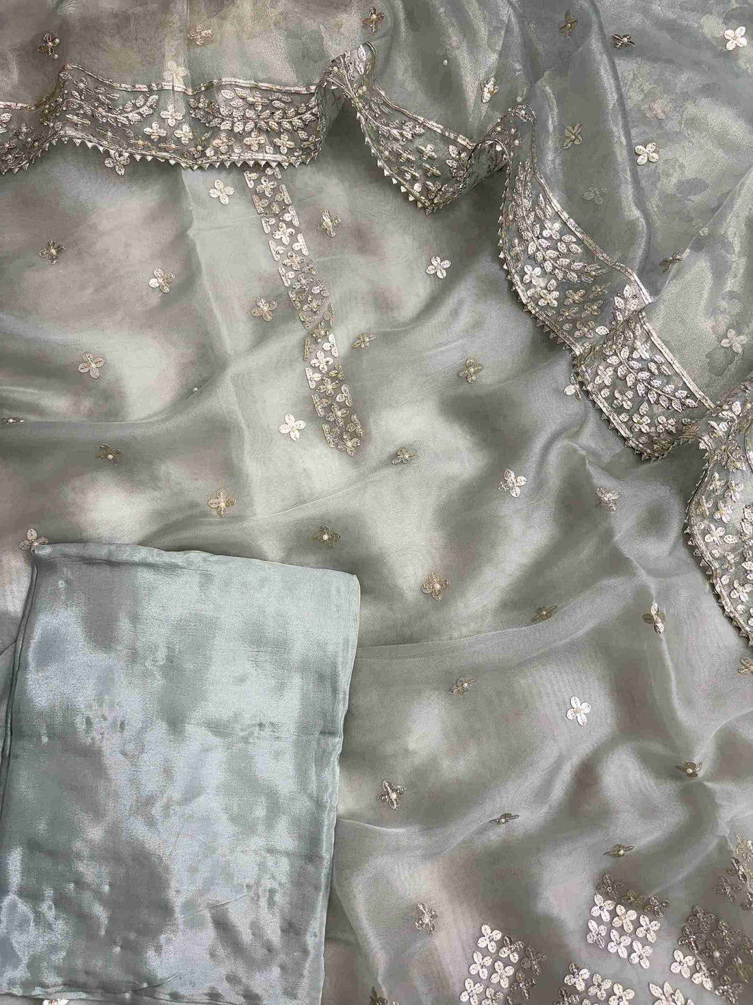 Complete Ice blue tissue unstitched suit flat lay set with shirt, dupatta, and opada silk bottom