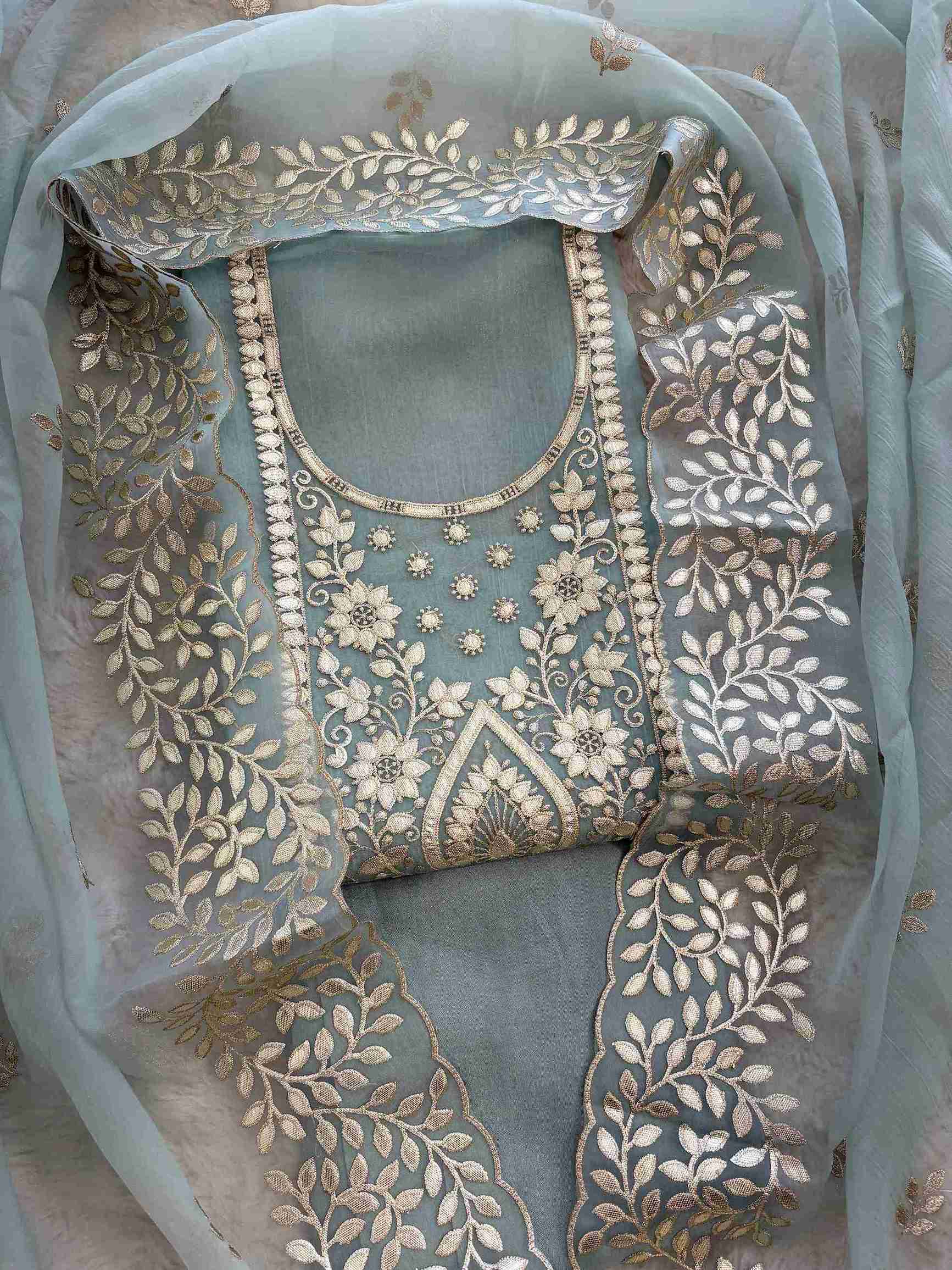 Leather gota border on the hemline of ice blue shimmer tissue suit