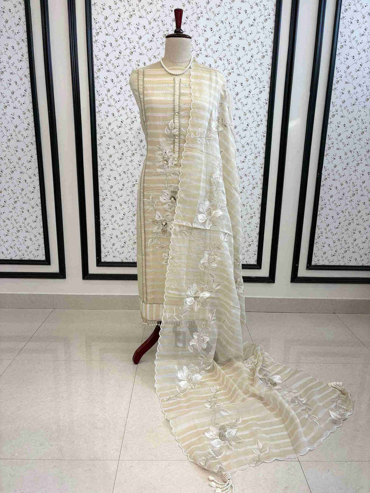 Ivory and gold soft tissue unstitched suit with resham floral motifs and striped dupatta on manequinn