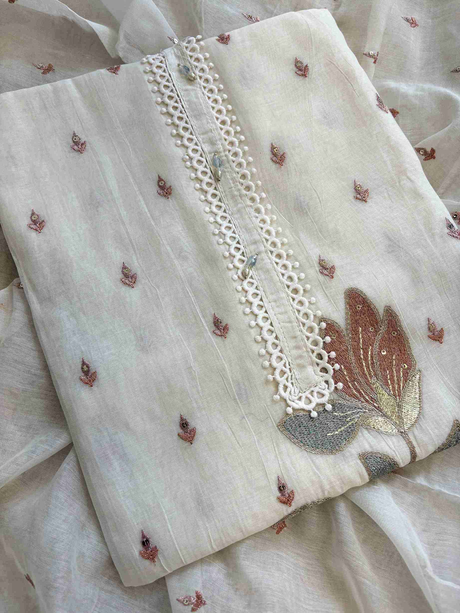 Close-up of floral resham and sequin work on ivory mul cotton neckline