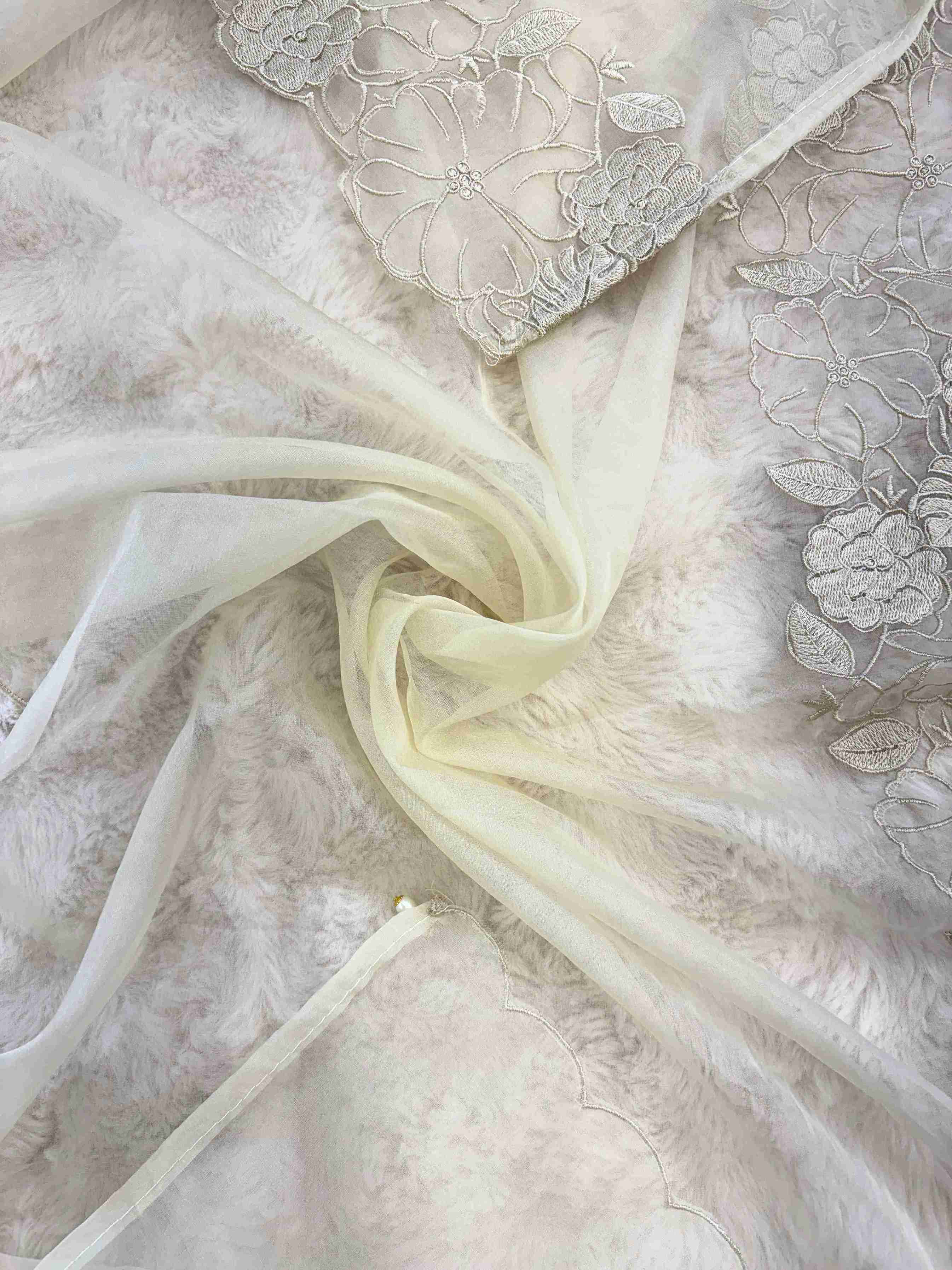Close-up of floral cutwork lace border on ivory organza dupatta