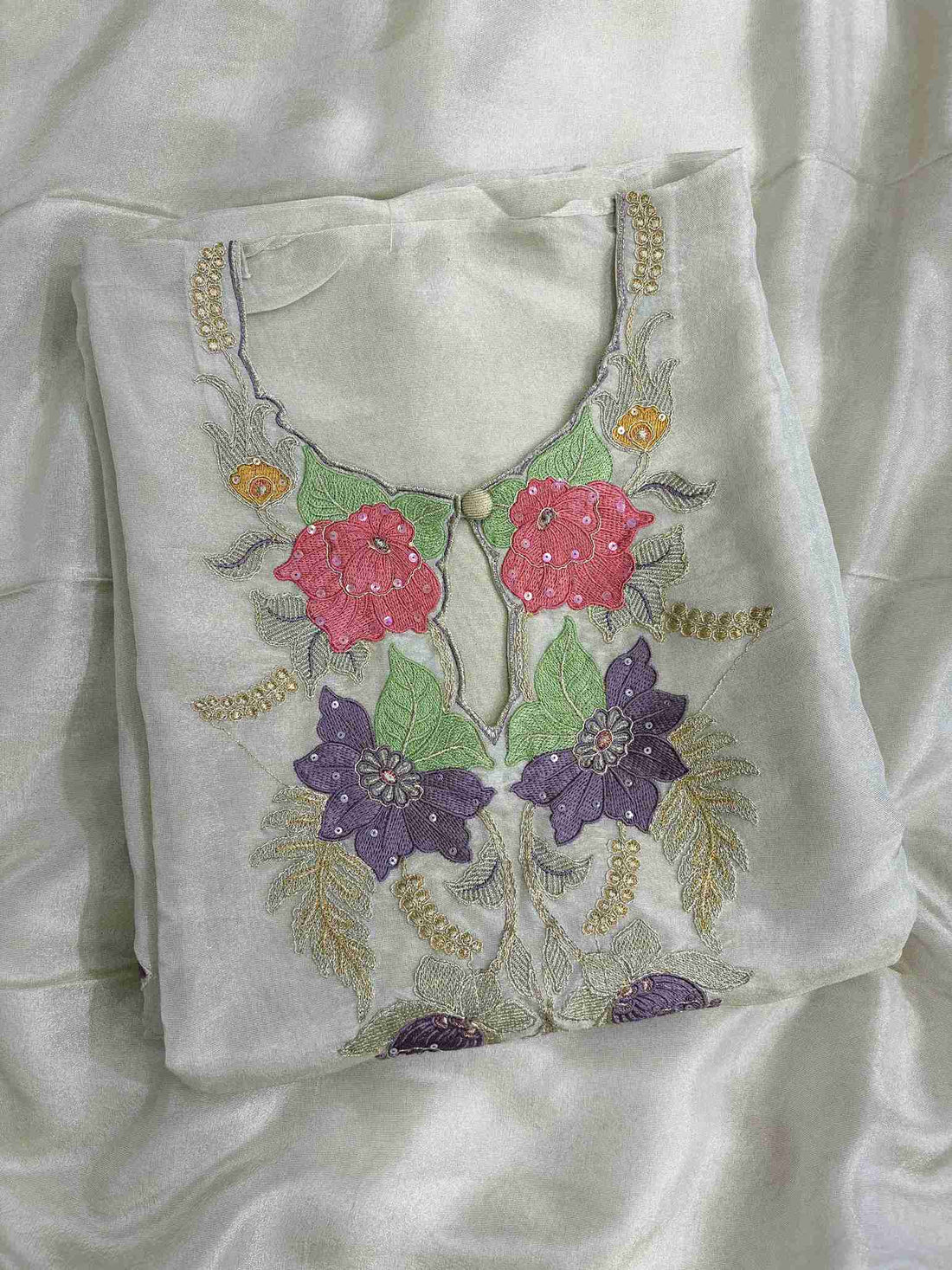 Detailed neckline with resham, zari and sequence work on organza suit
