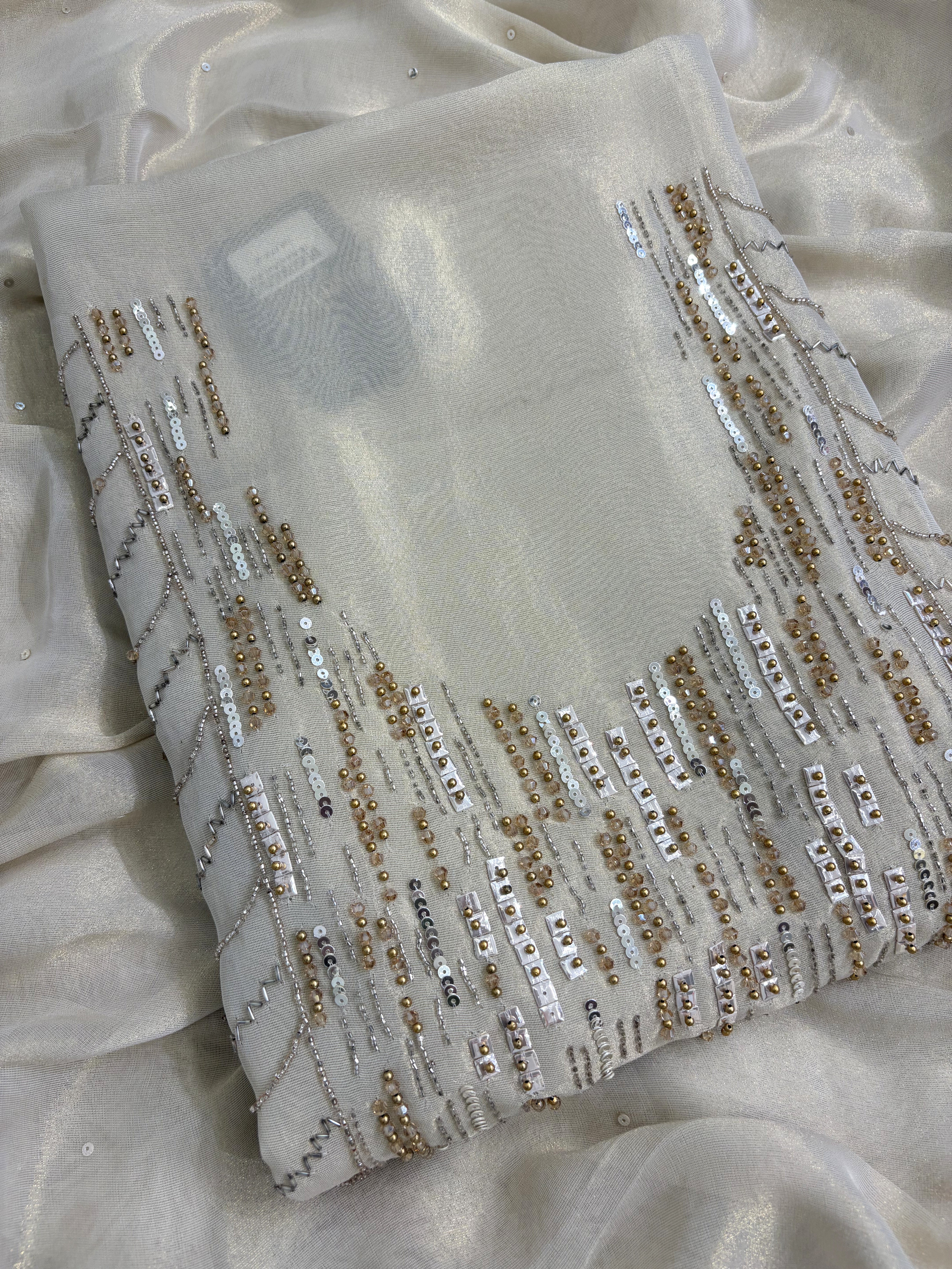 Close up of heavy bead and sequence embroidery on ivory shimmer tissue shirt