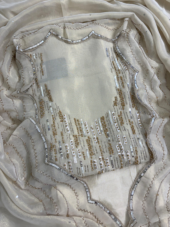 Ivory shimmer tissue suit front view with heavy beads and sequence work