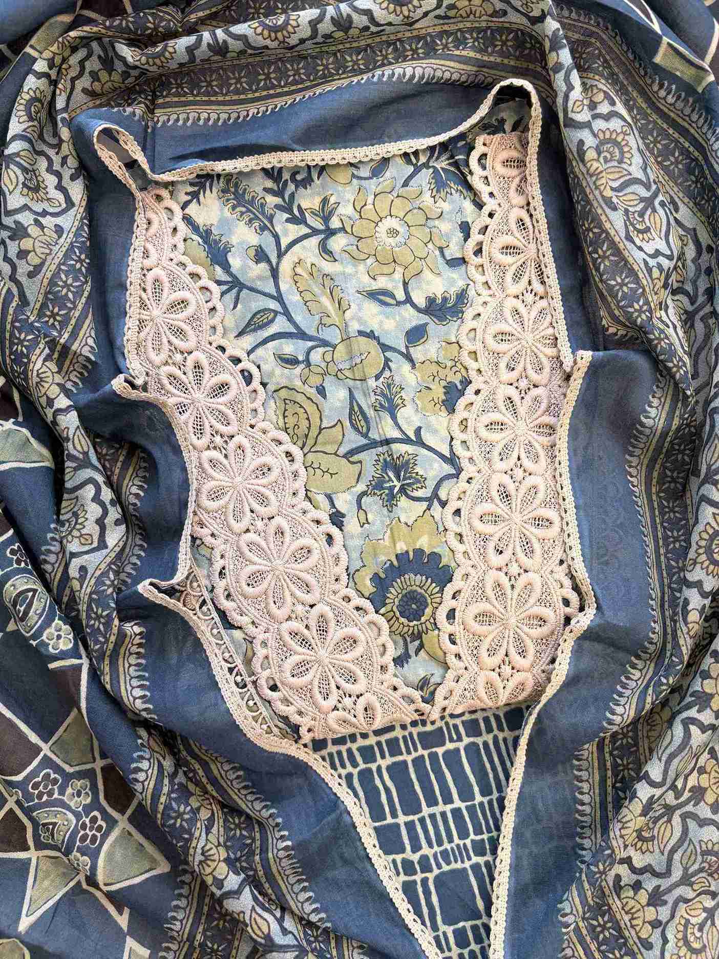 Close-up of all-over digital floral print with blooms and botanical motifs on jade green cotton shirt body