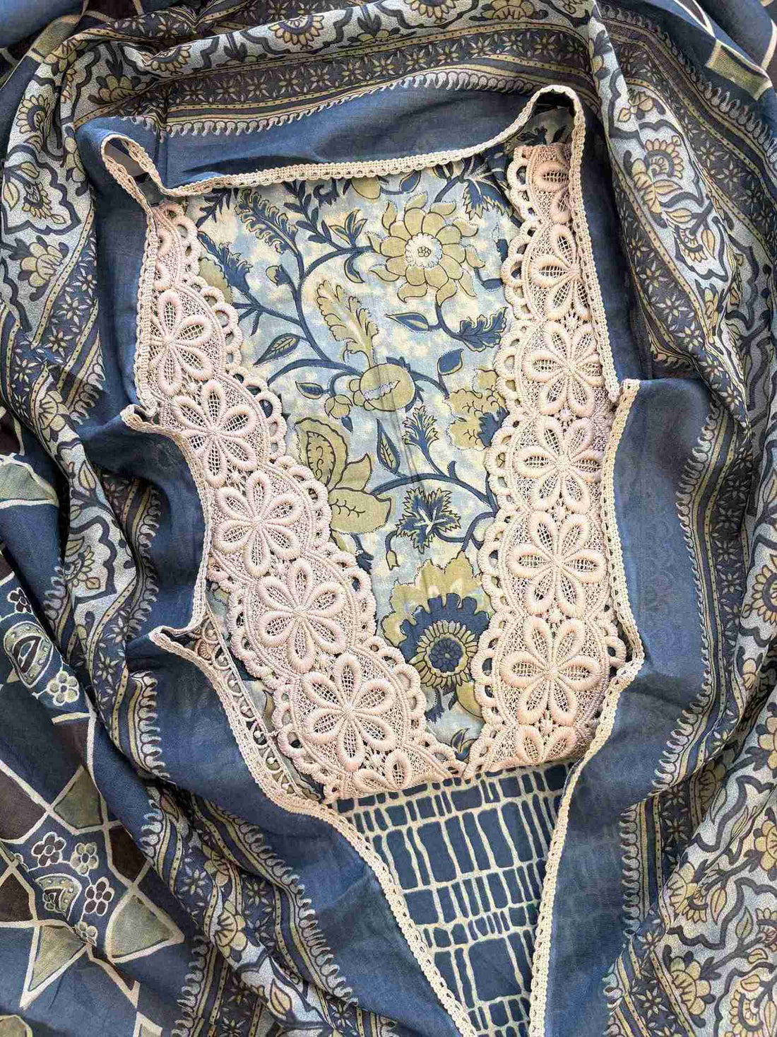 Close-up of all-over digital floral print with blooms and botanical motifs on jade green cotton shirt body