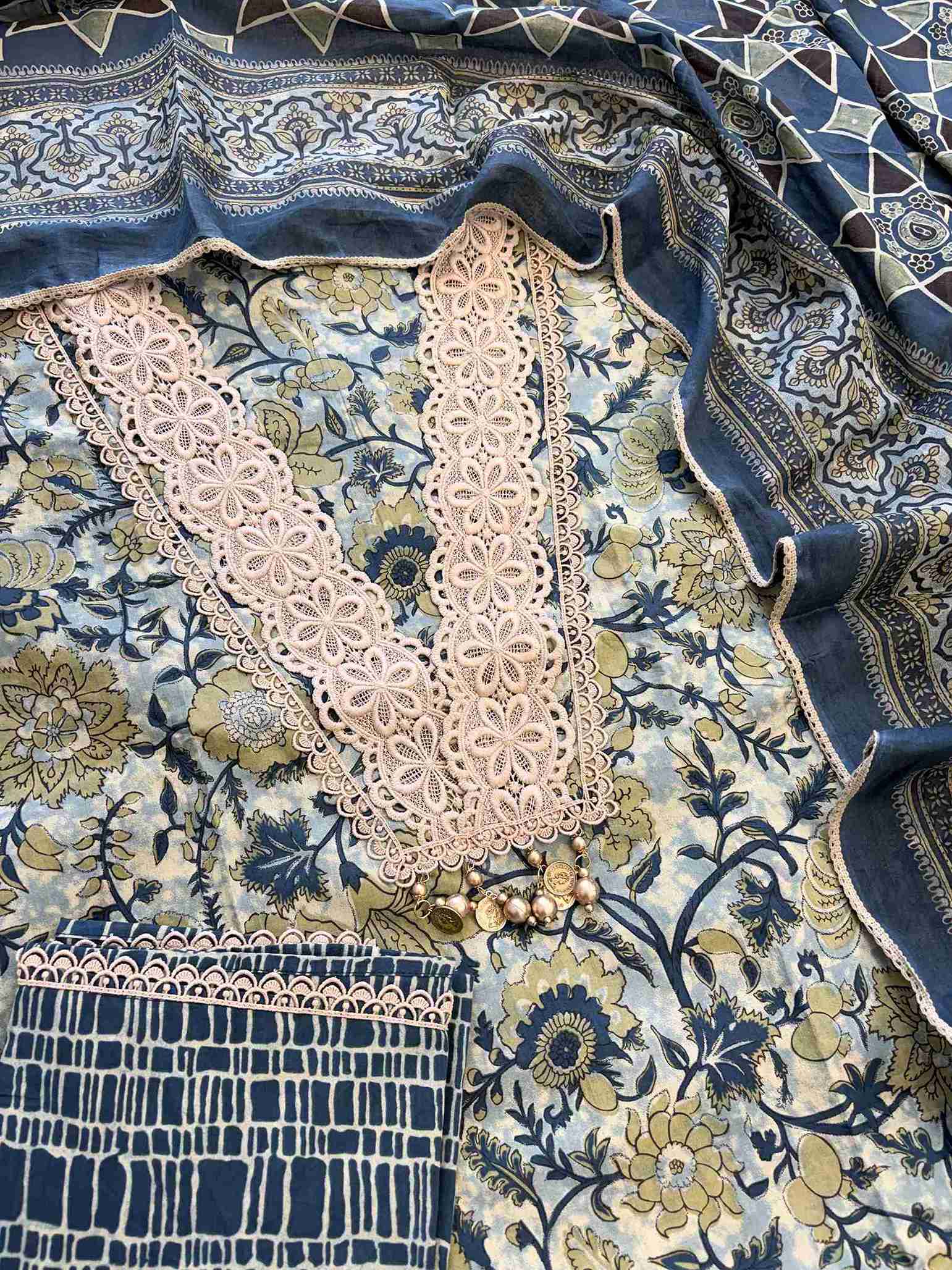 Complete jade green cotton unstitched suit flat lay set with floral printed shirt, steel blue dupatta, and matching printed bottom