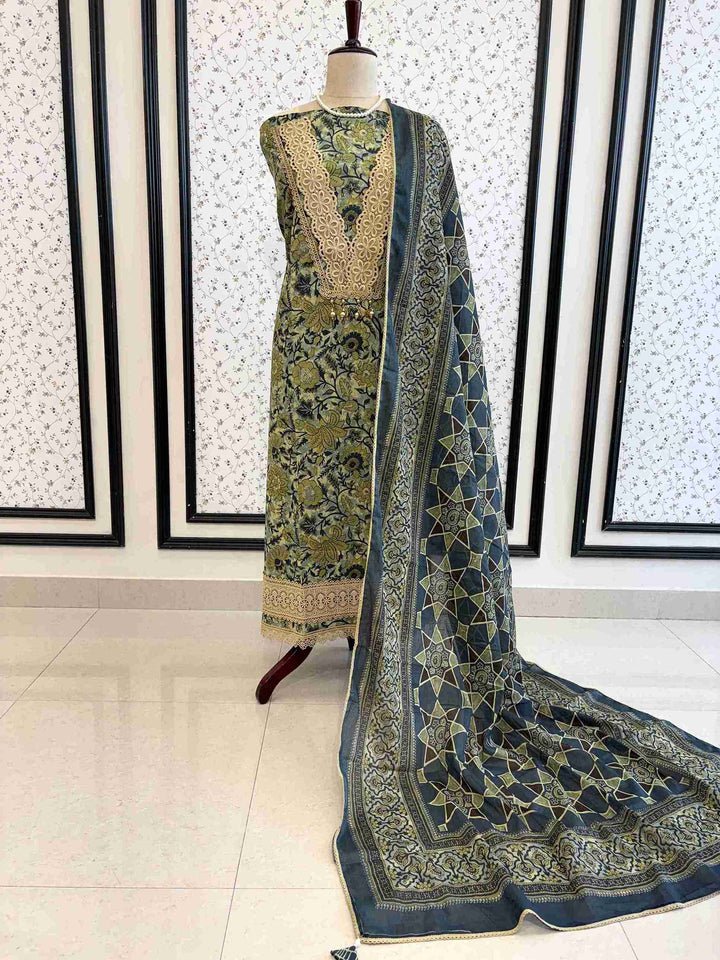 Jade green cotton unstitched suit full front view with steel blue geometric star print dupatta draped on mannequin