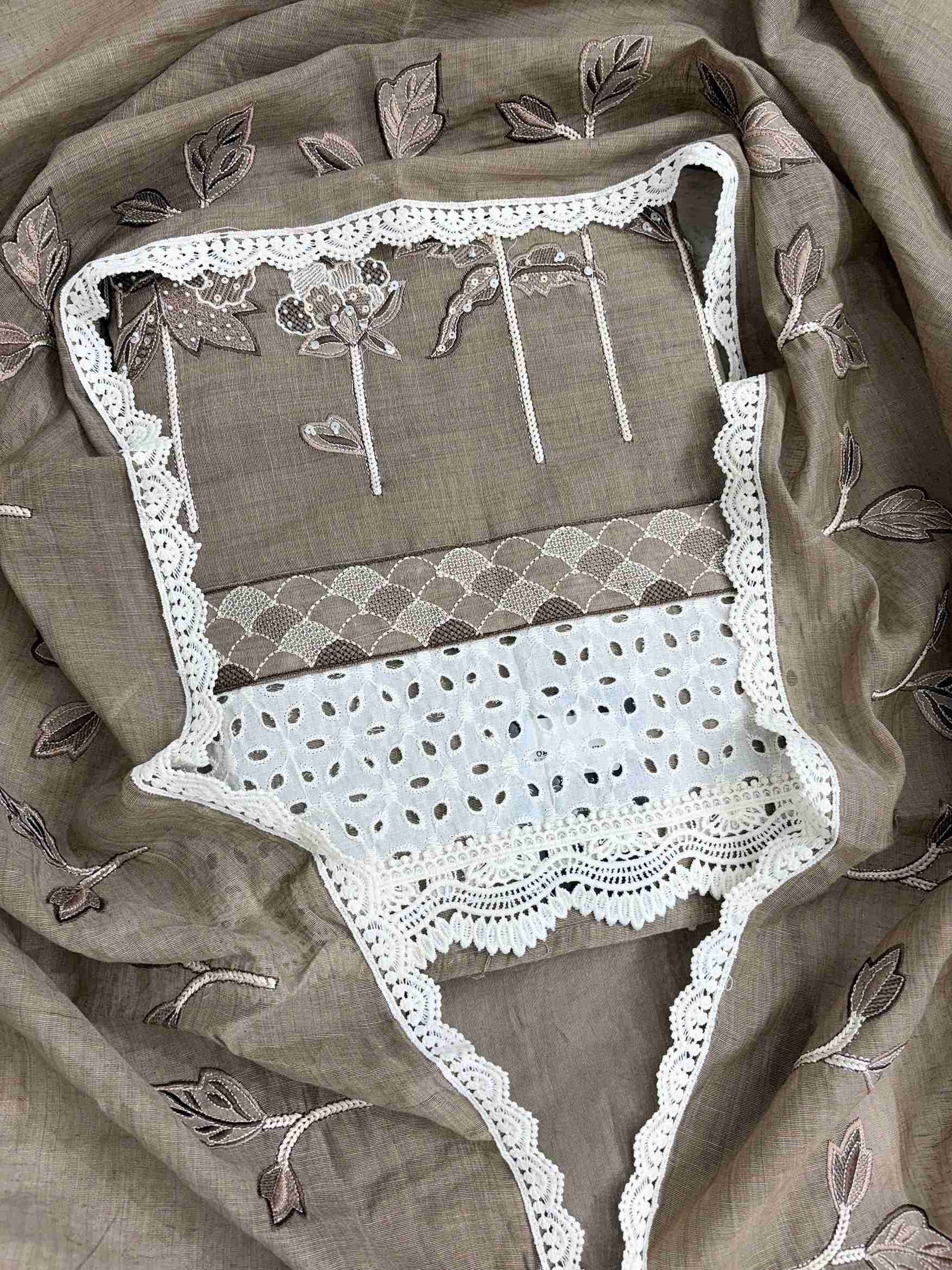 Close-up of thread embroidery with sequin and bead work on khakhi mul chanderi shirt