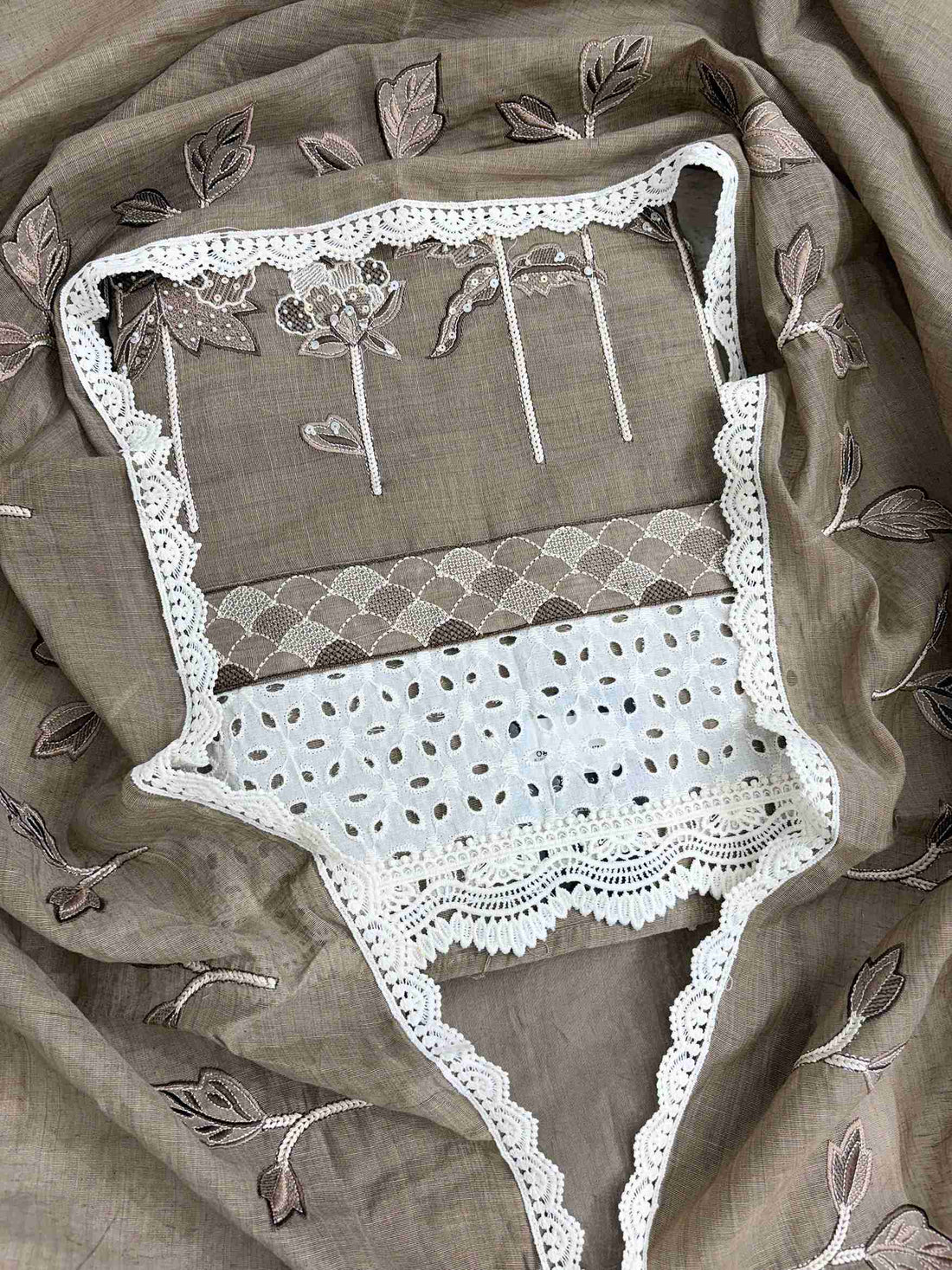 Close-up of thread embroidery with sequin and bead work on khakhi mul chanderi shirt