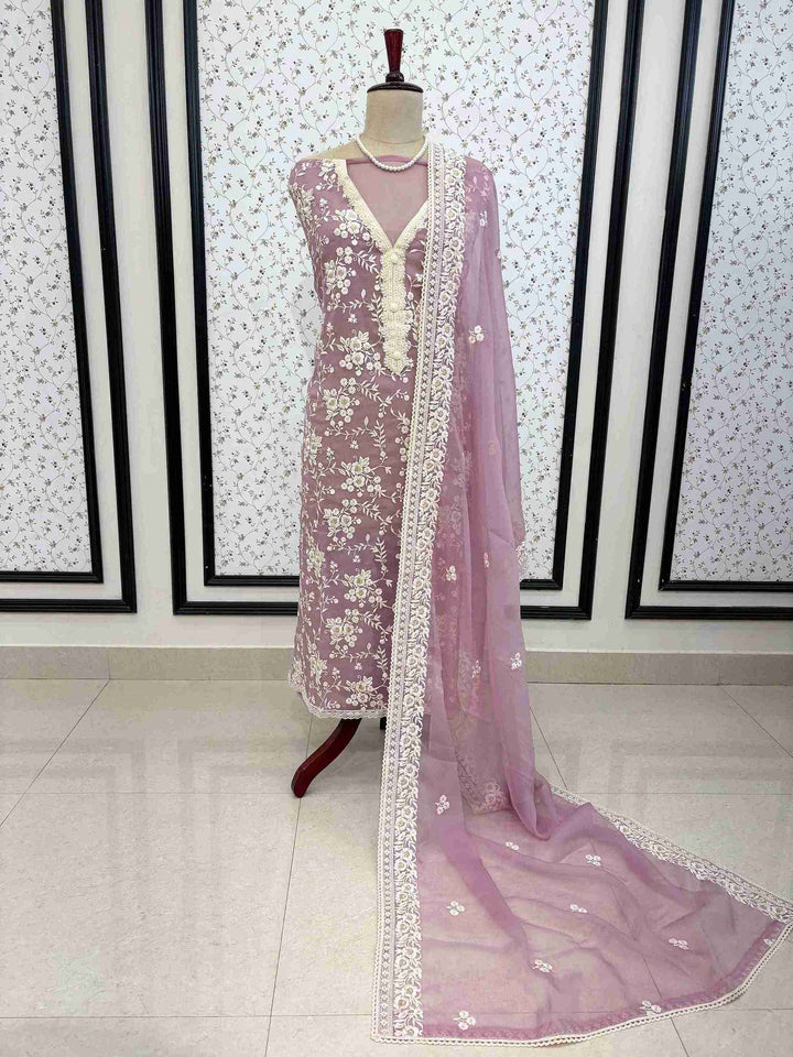 Flat lay of lavendar chiffon embroidered unstitched suit set