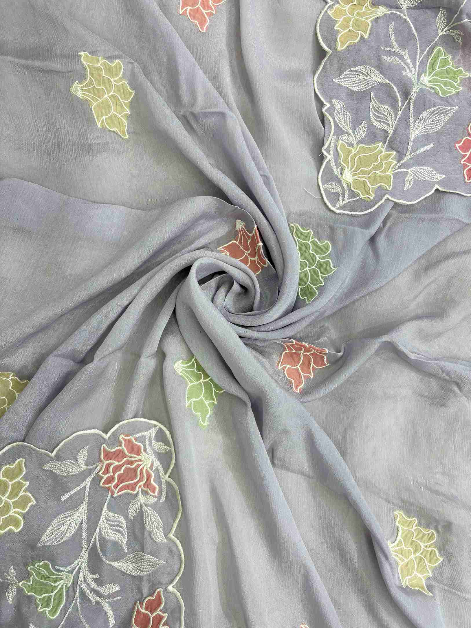 Applique floral motif at corner of lavendar chinnon dupatta with cutwork border finishing