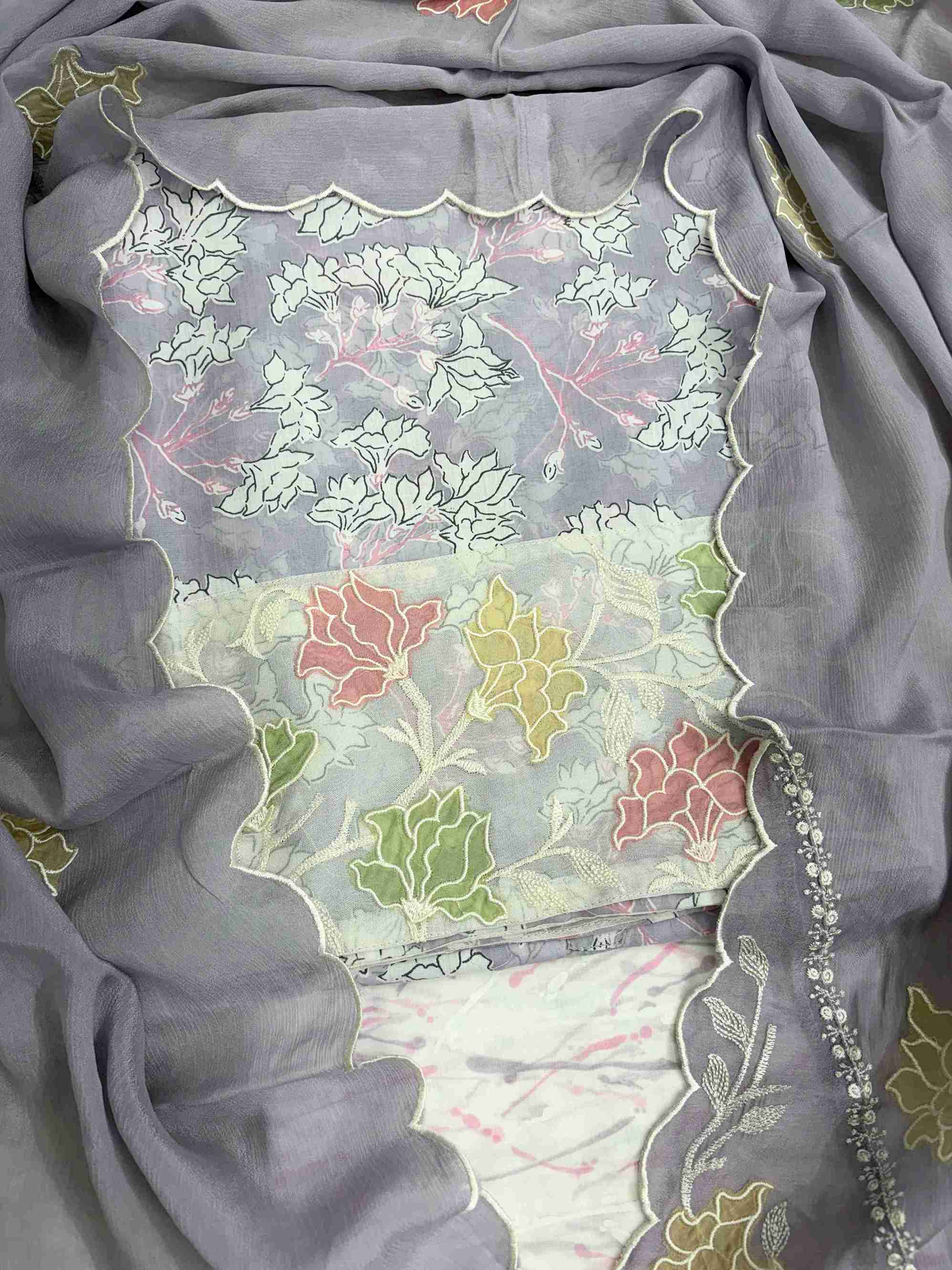 Close-up of all-over white floral print with blooming clusters and branches on pink cotton shirt body