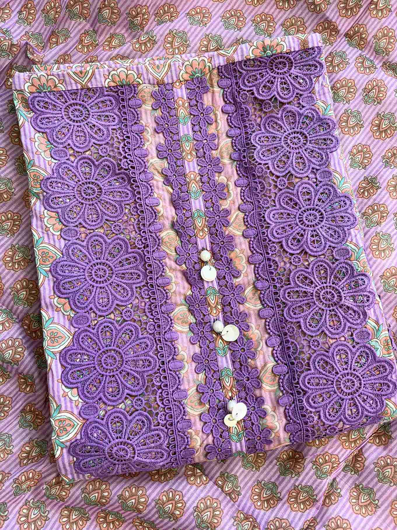 rectangle shaped neckline with broad tone-on-tone purple crotia lace highlighting and moti tassels on lavender cotton shirt