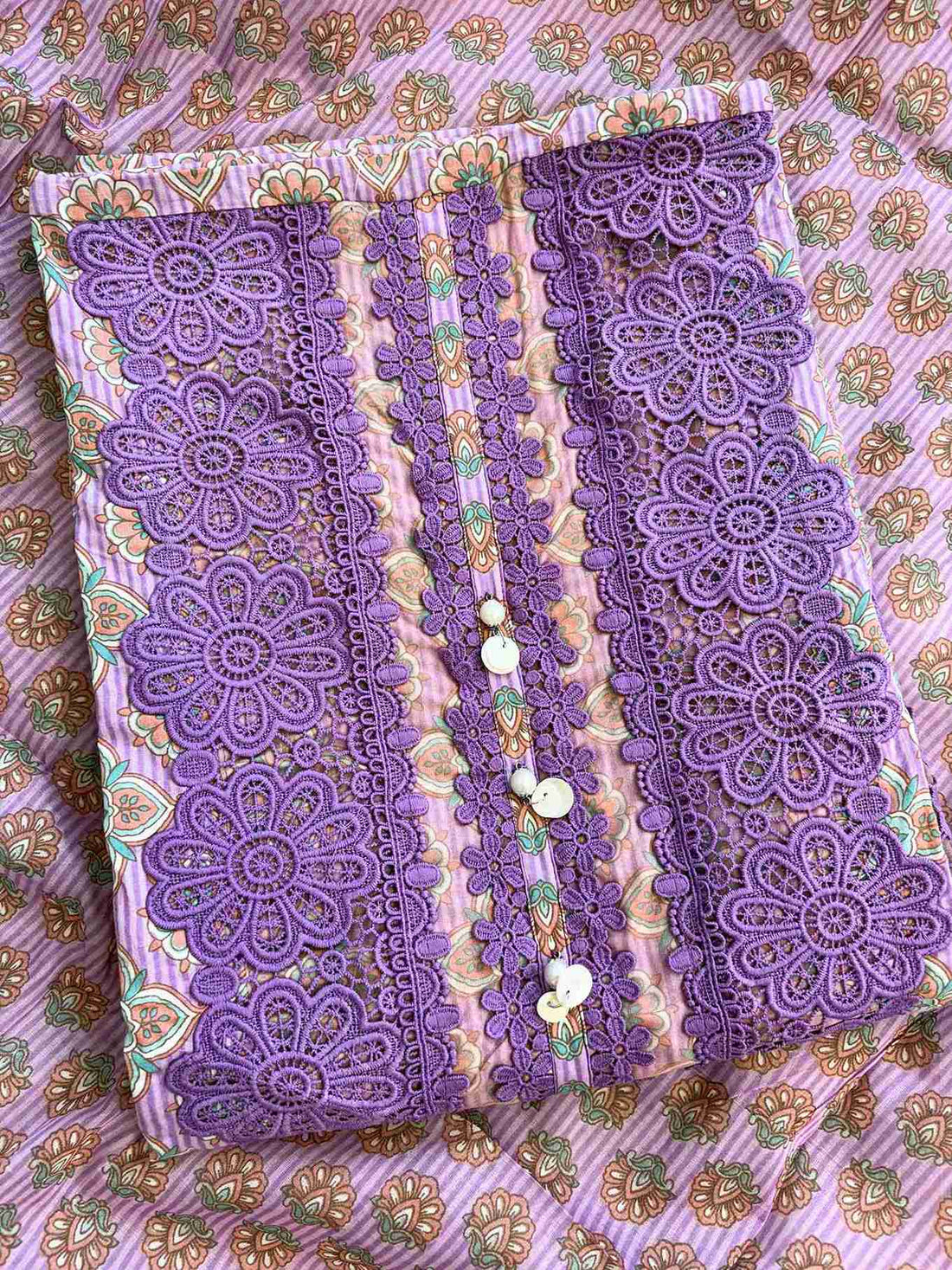 rectangle shaped neckline with broad tone-on-tone purple crotia lace highlighting and moti tassels on lavender cotton shirt