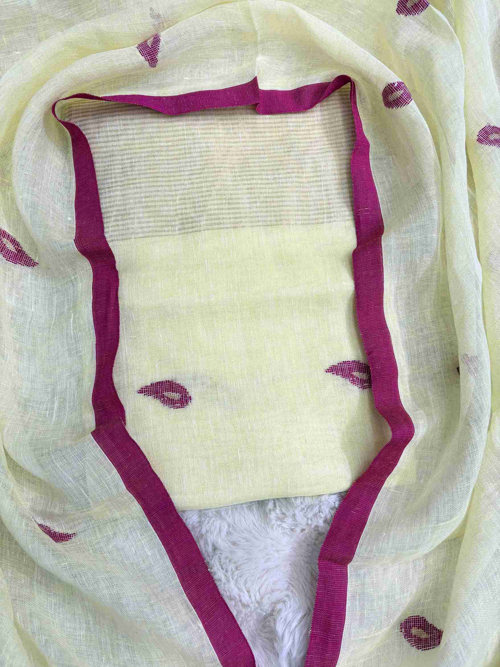Complete lemon yellow linen unstitched 2-piece suit flat lay with shirt and dupatta showing pink paisley motifs and golden stripe