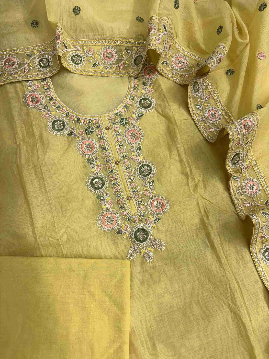 Complete lemon yellow mul chanderi unstitched suit flat lay set with shirt, dupatta, and matching cotton bottom