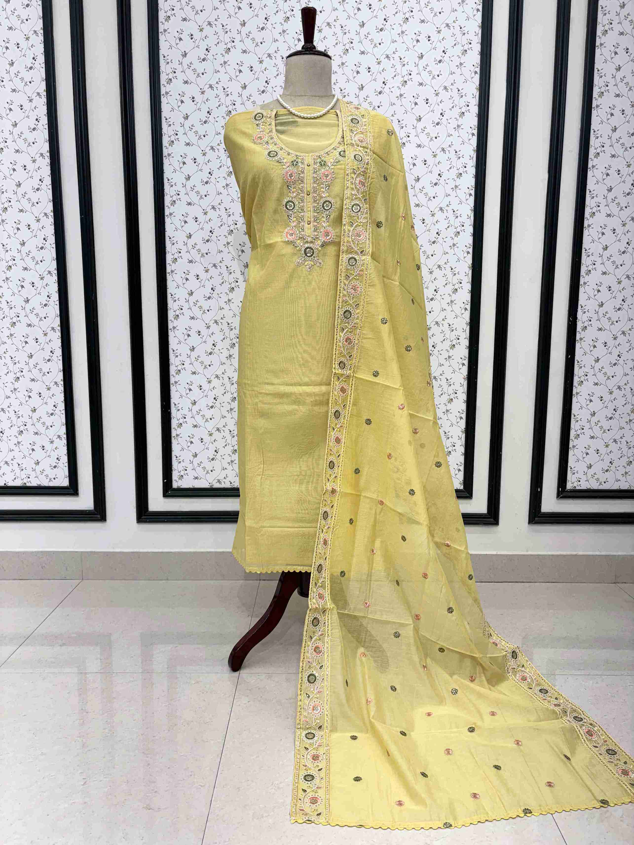 Lemon yellow mul chanderi unstitched suit full front view with embroidered booty dupatta draped on mannequin