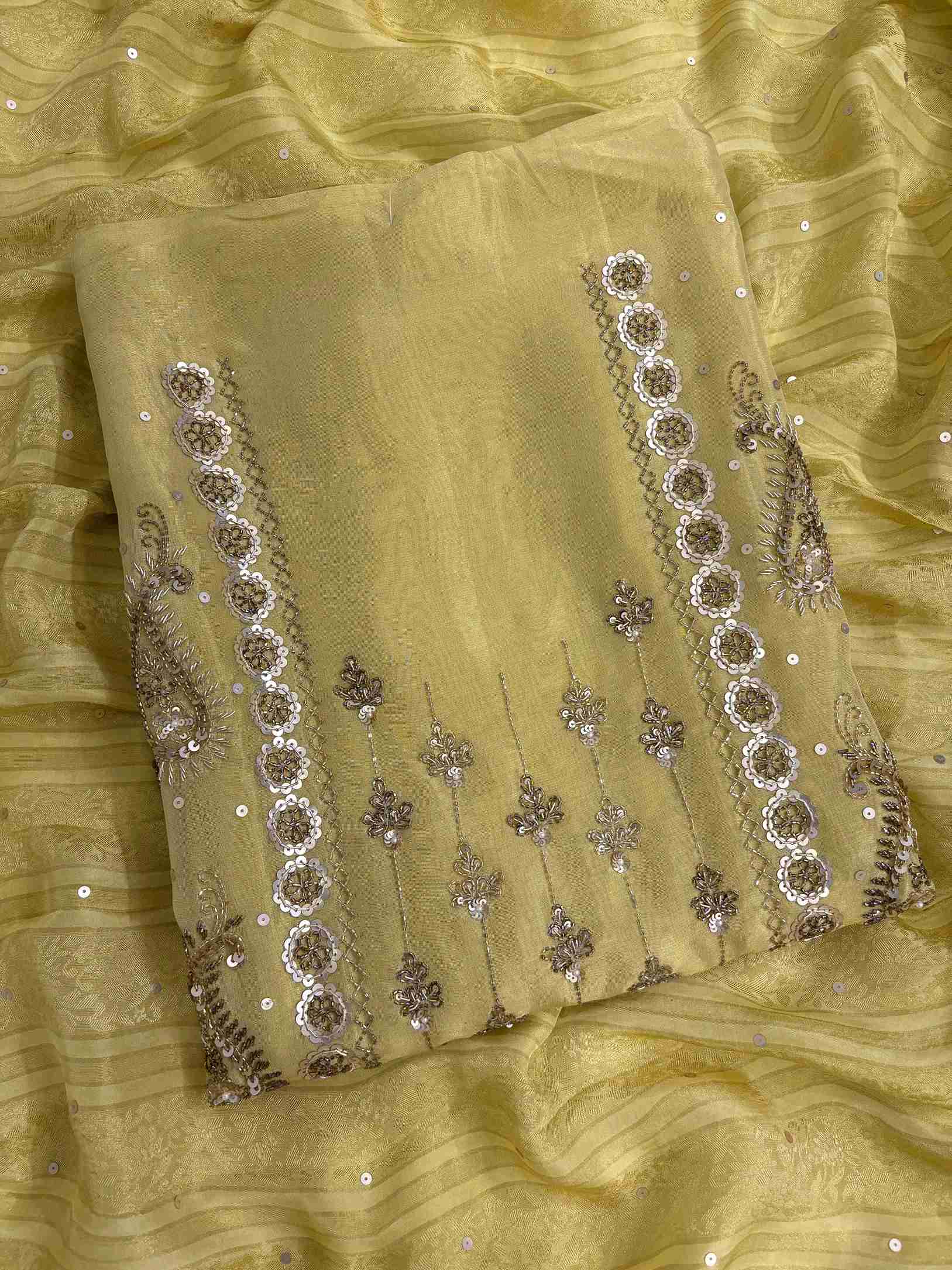 Close up of nalki, sequence and cutdana hand embroidery on lemon yellow shimmer organza shirt
