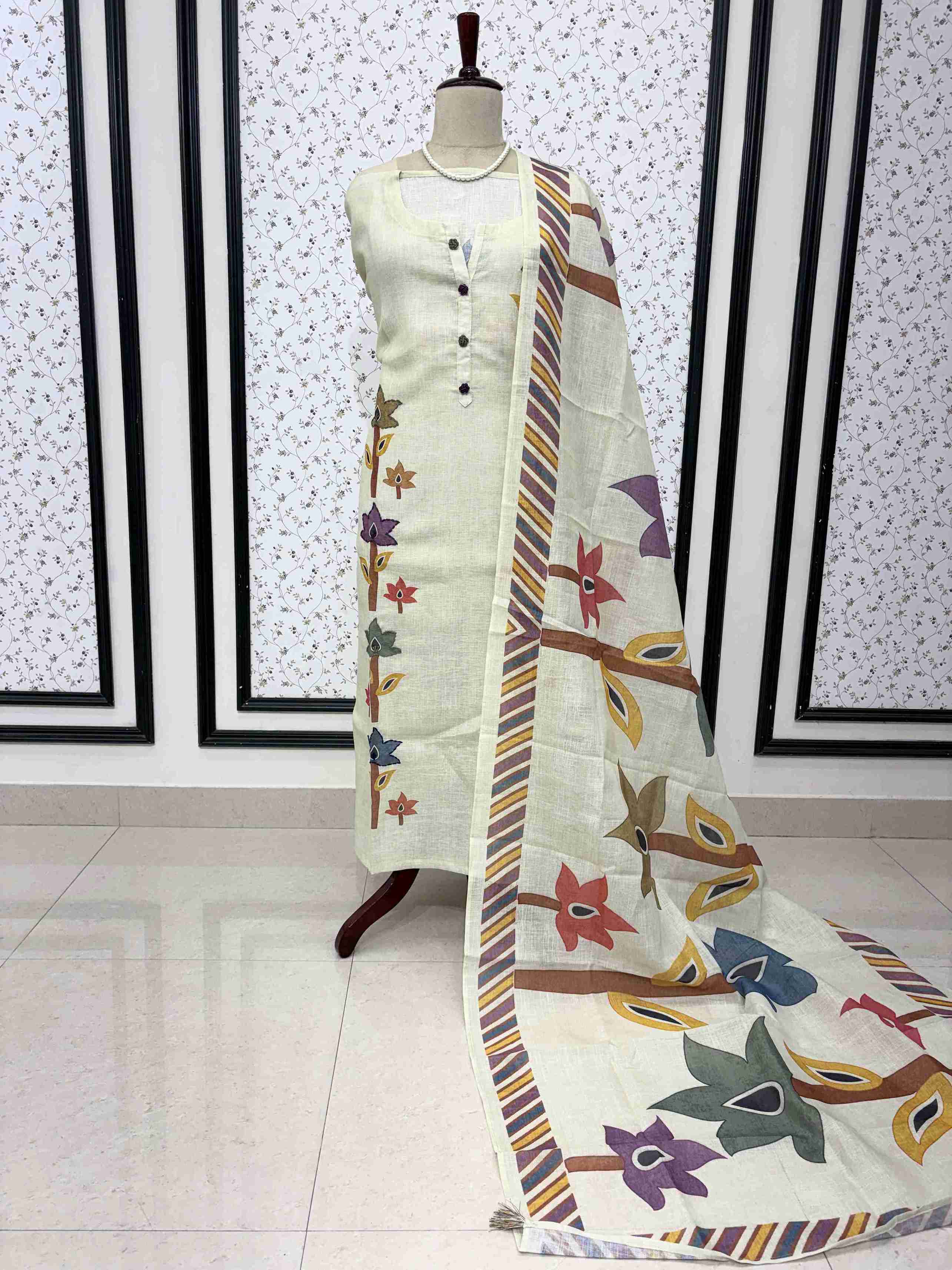 Light pista linen unstitched suit full front view with geometric botanical print dupatta draped on mannequin