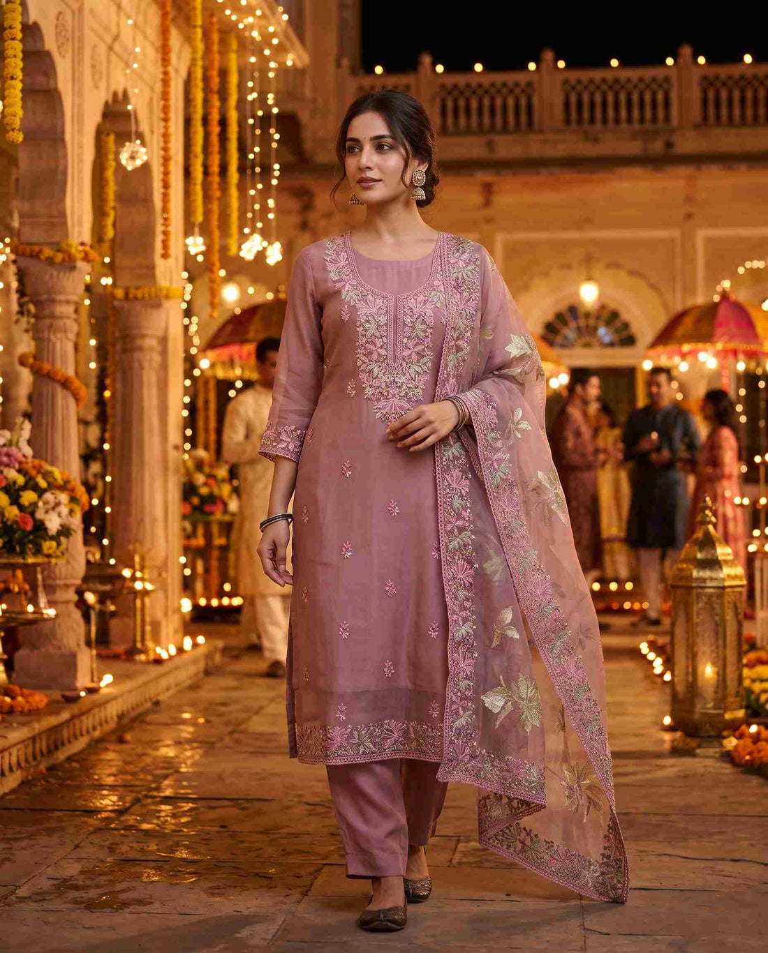 	Close-up of floral thread embroidery on the neckline of mauve pink glass organza suit