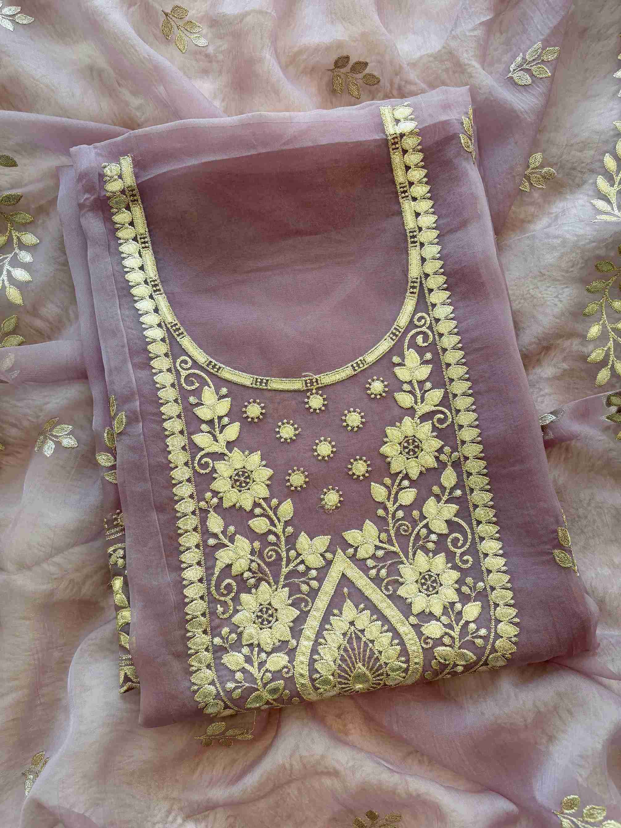 Leather gota border on the hemline of mauve shimmer tissue suit