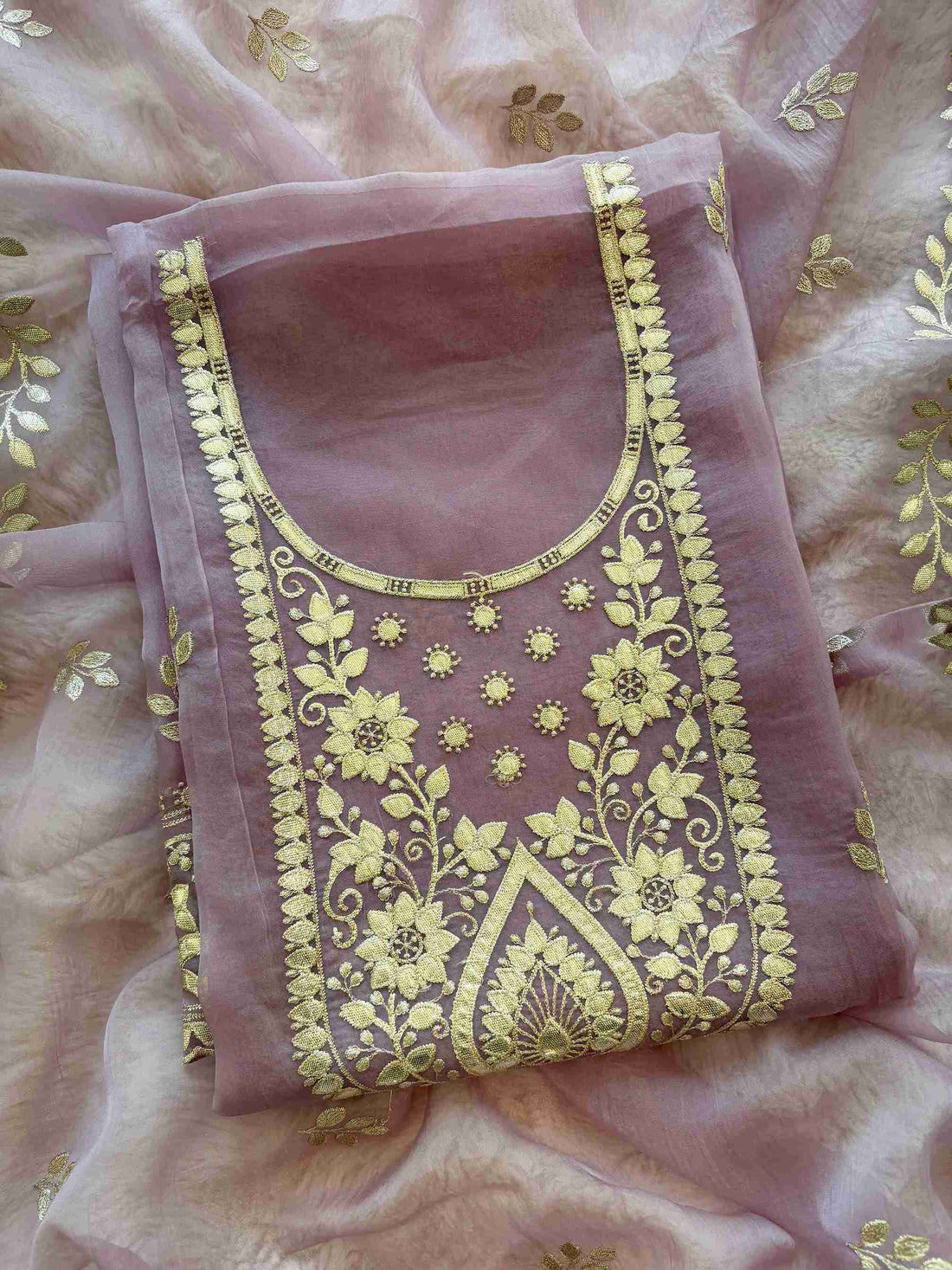 Leather gota border on the hemline of mauve shimmer tissue suit