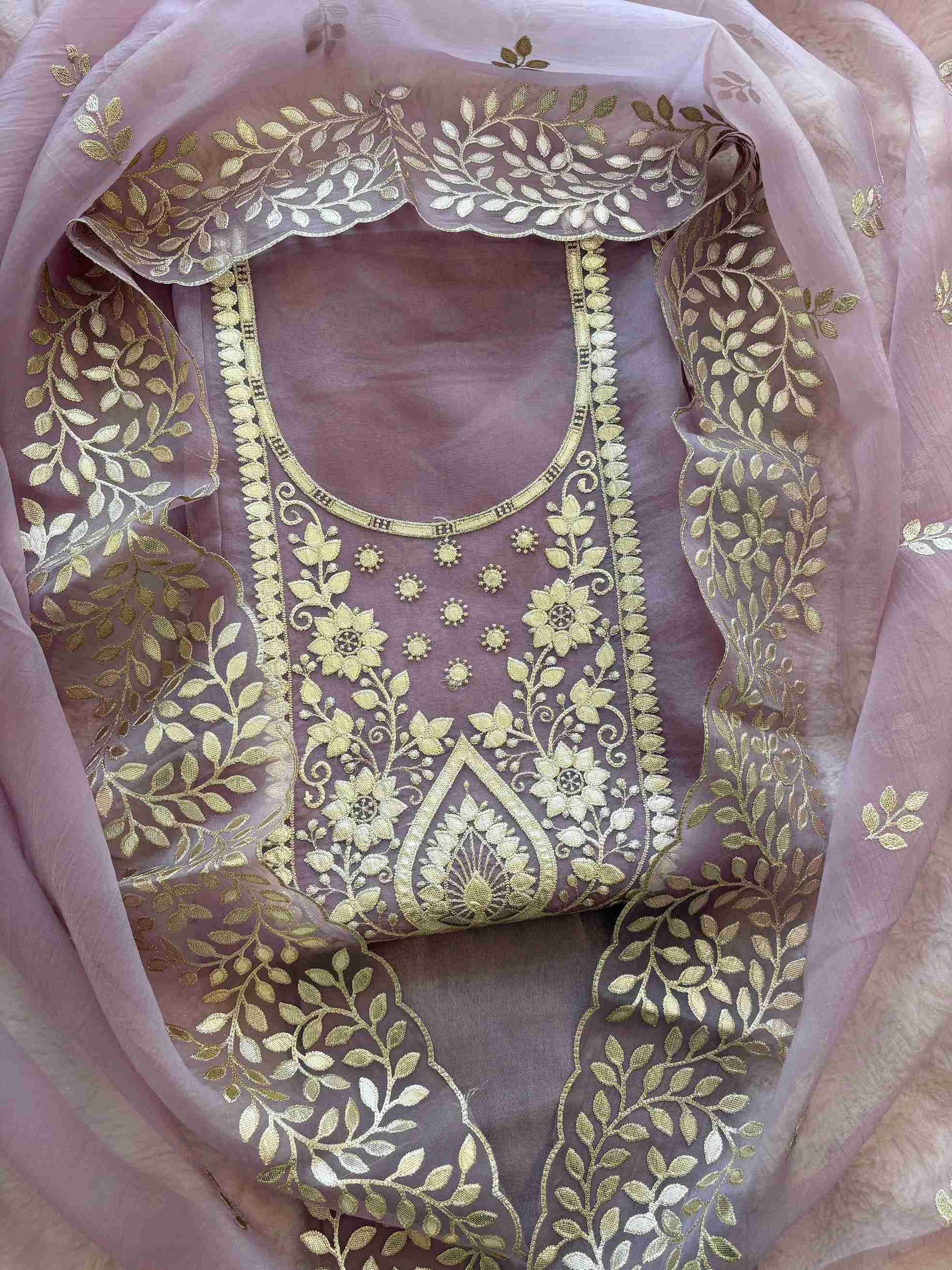 Close-up of leather gota work neckline on mauve shimmer tissue suit