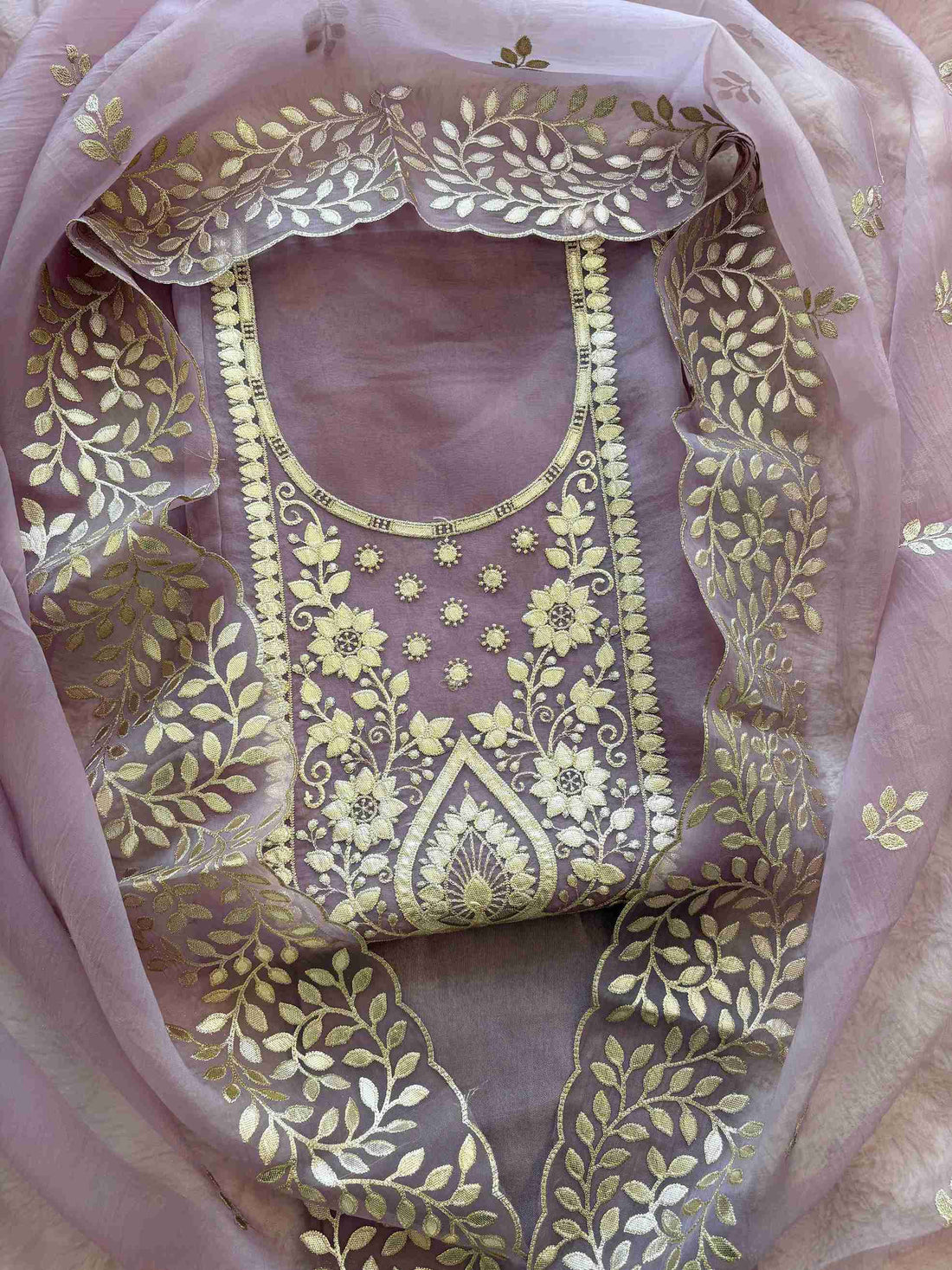 Close-up of leather gota work neckline on mauve shimmer tissue suit