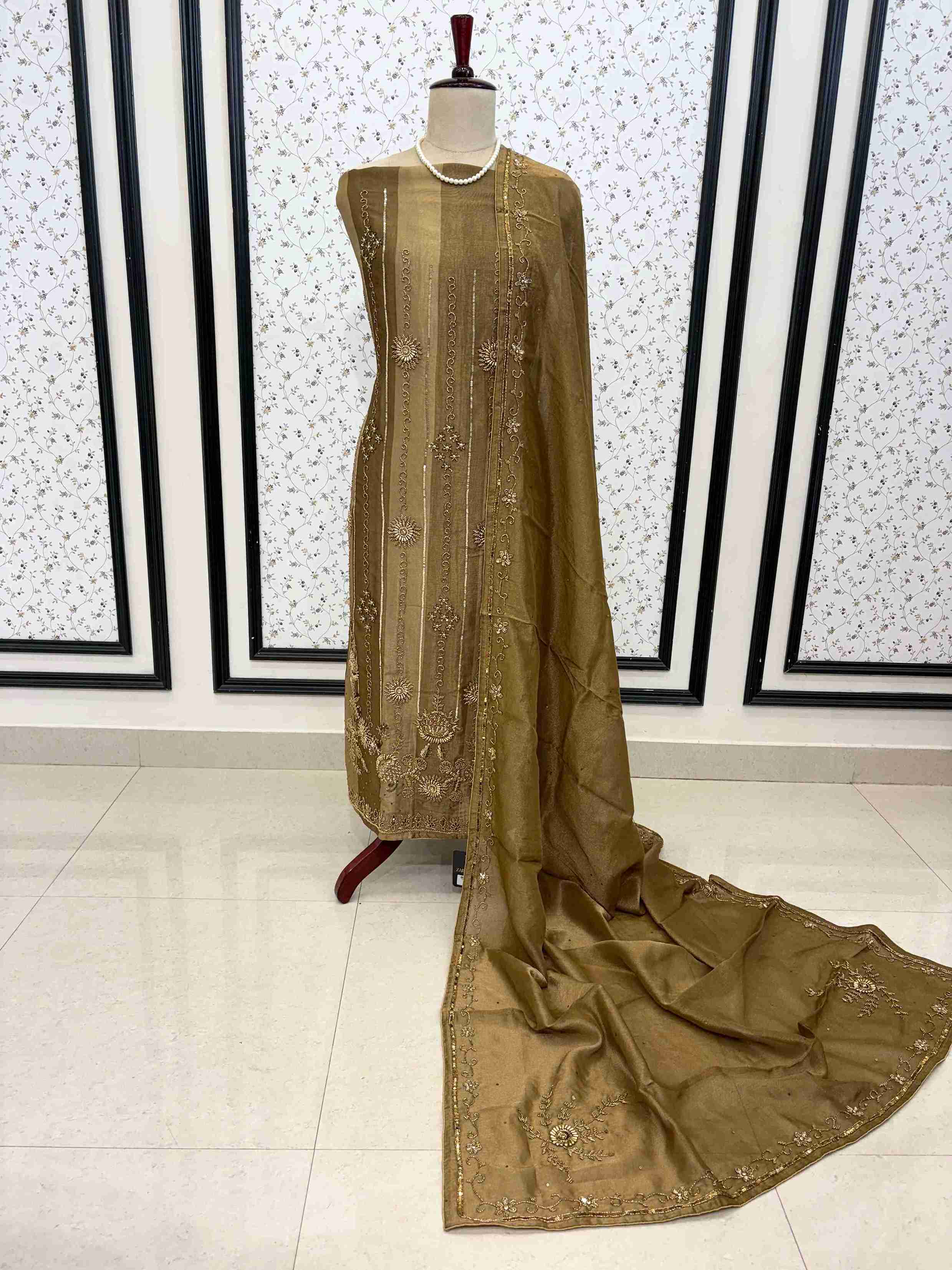 Metallic bronze shimmer tissue fabric texture with detailed hand embroidery