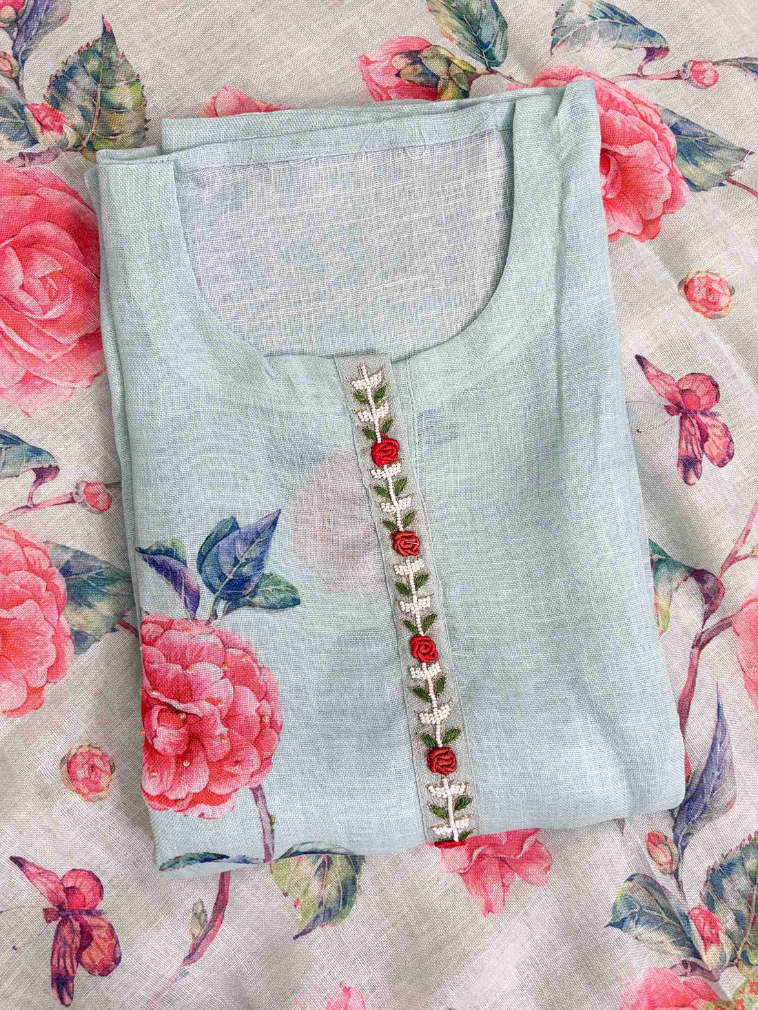Single placement floral motif at neckline of mint blue linen unstitched shirt
