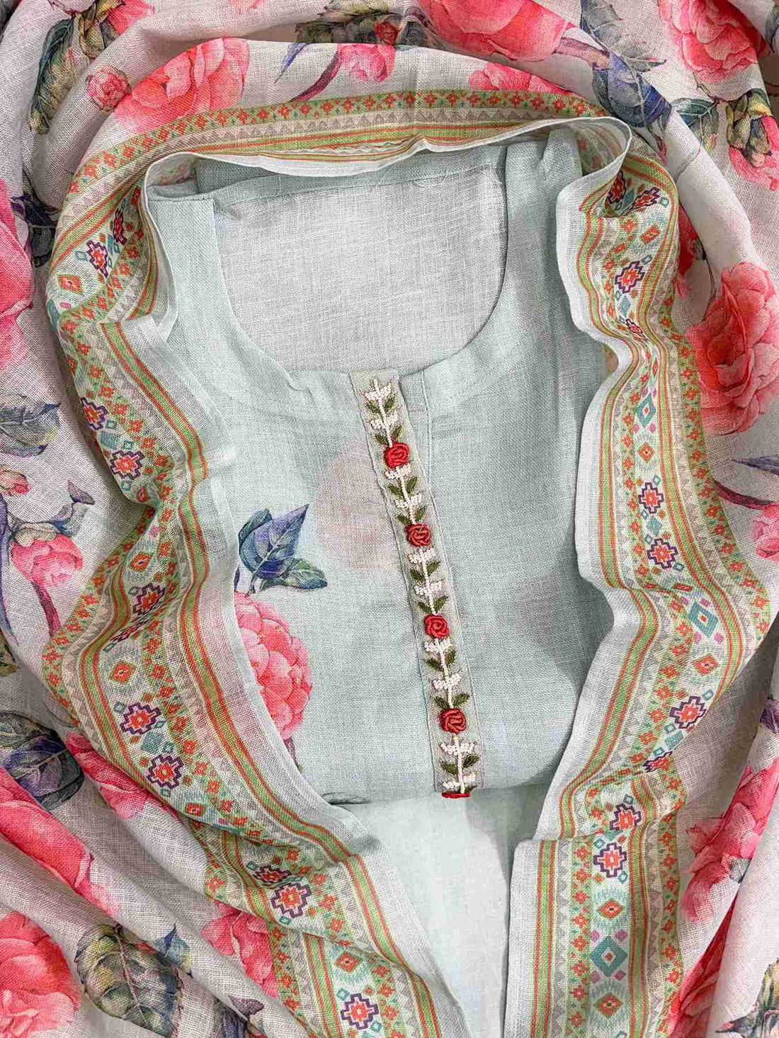 Thread embroidered neckline and front placket with bead highlighting on mint blue linen shirt