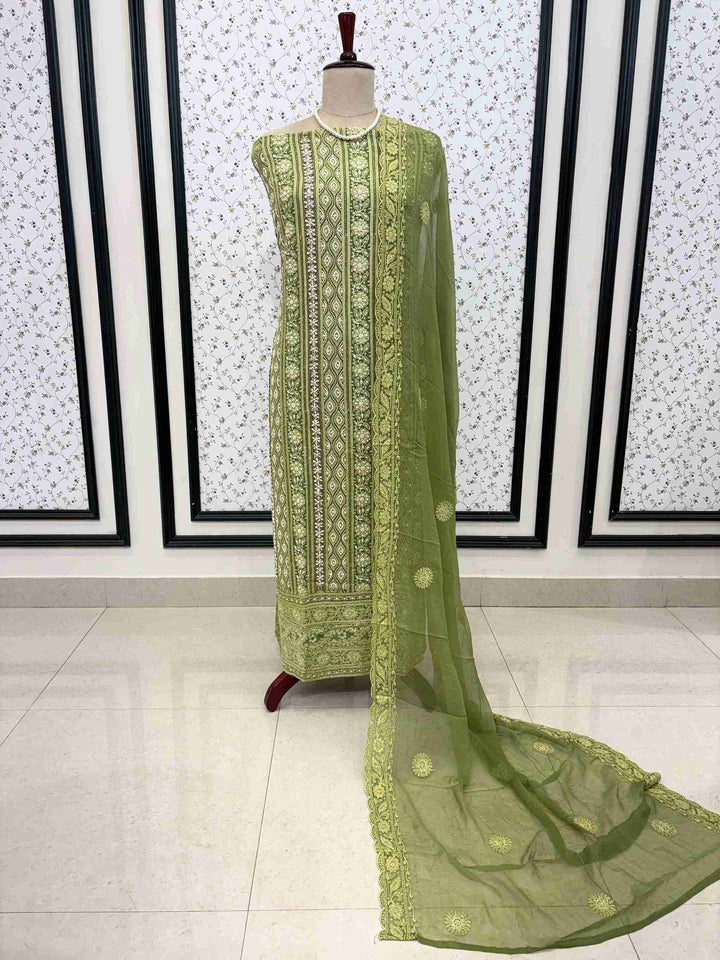 Detailed view of chikankari border work on mint green suit fabric