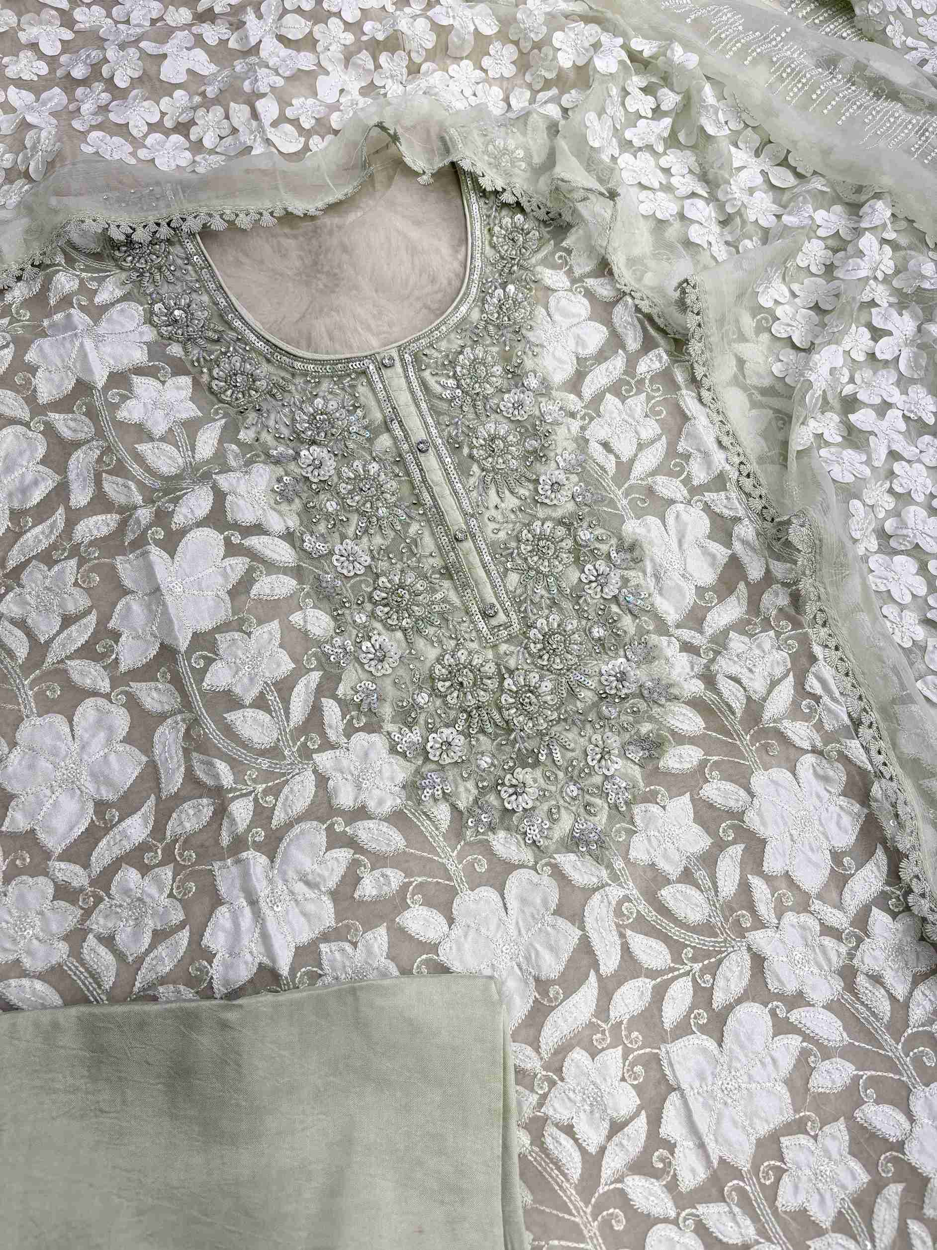 Complete mint green organza unstitched suit flat lay set with shirt, chiffon dupatta, and opada silk bottom