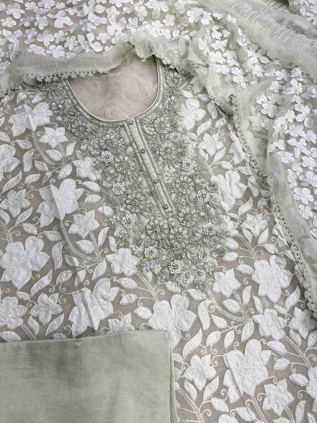 Complete mint green organza unstitched suit flat lay set with shirt, chiffon dupatta, and opada silk bottom