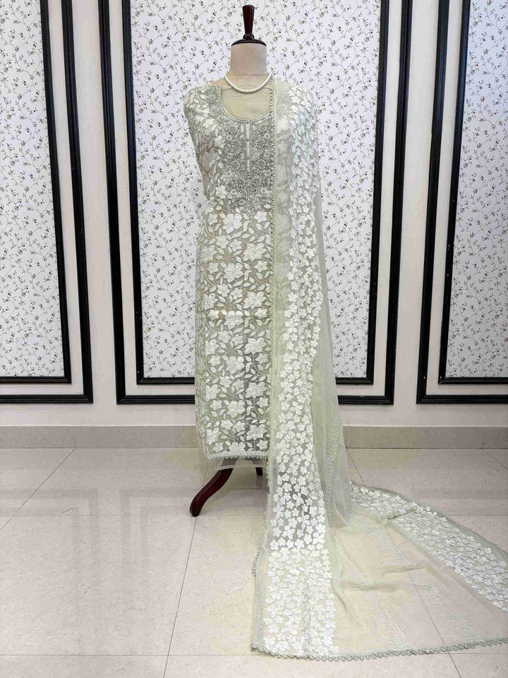 Mint Green organza unstitched suit full front view with white floral applique and four-sided lace chiffon dupatta draped on mannequin