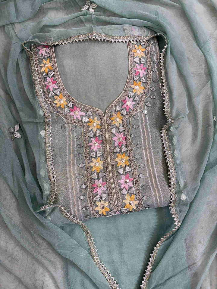 Gota floral motifs, mirror motifs, and vertical gota lanes across the full length panel of mint green shimmer tissue shirt