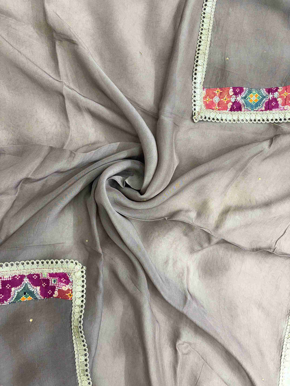 Shimmering mirror lace border finishing along edges of mocha brown organza dupatta