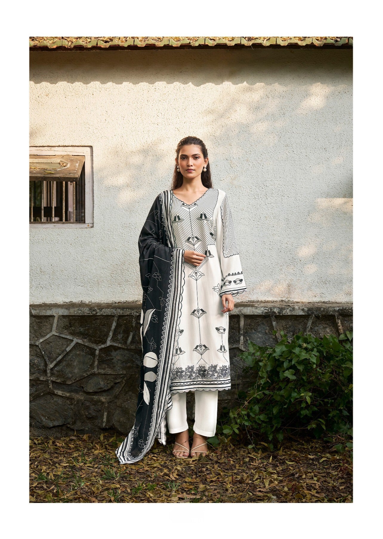 model wearing black and white muslin suit