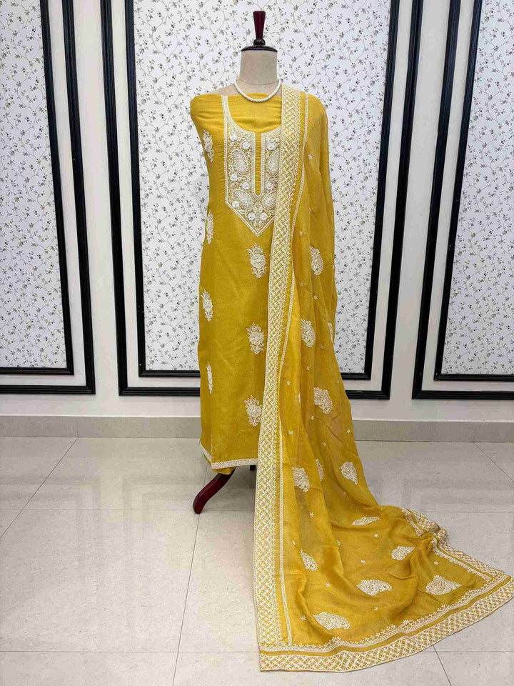 Mustard chikankari unstitched georgette suit set with tissue dupatta on manequinn