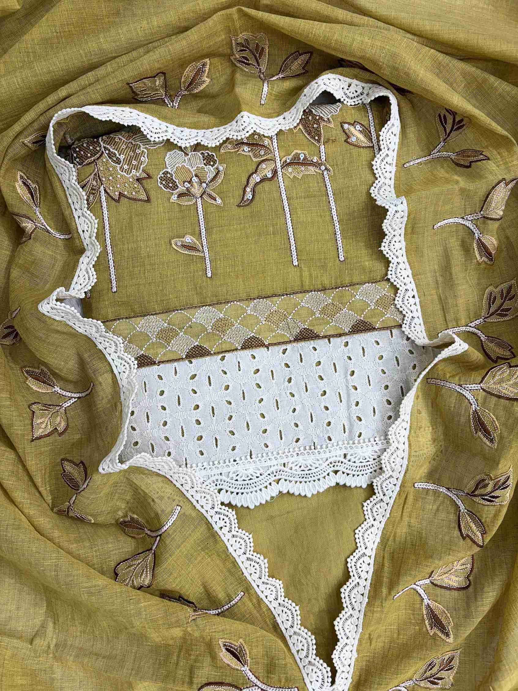 Close-up of thread embroidery with sequin and bead work on mustard mul chanderi shirt