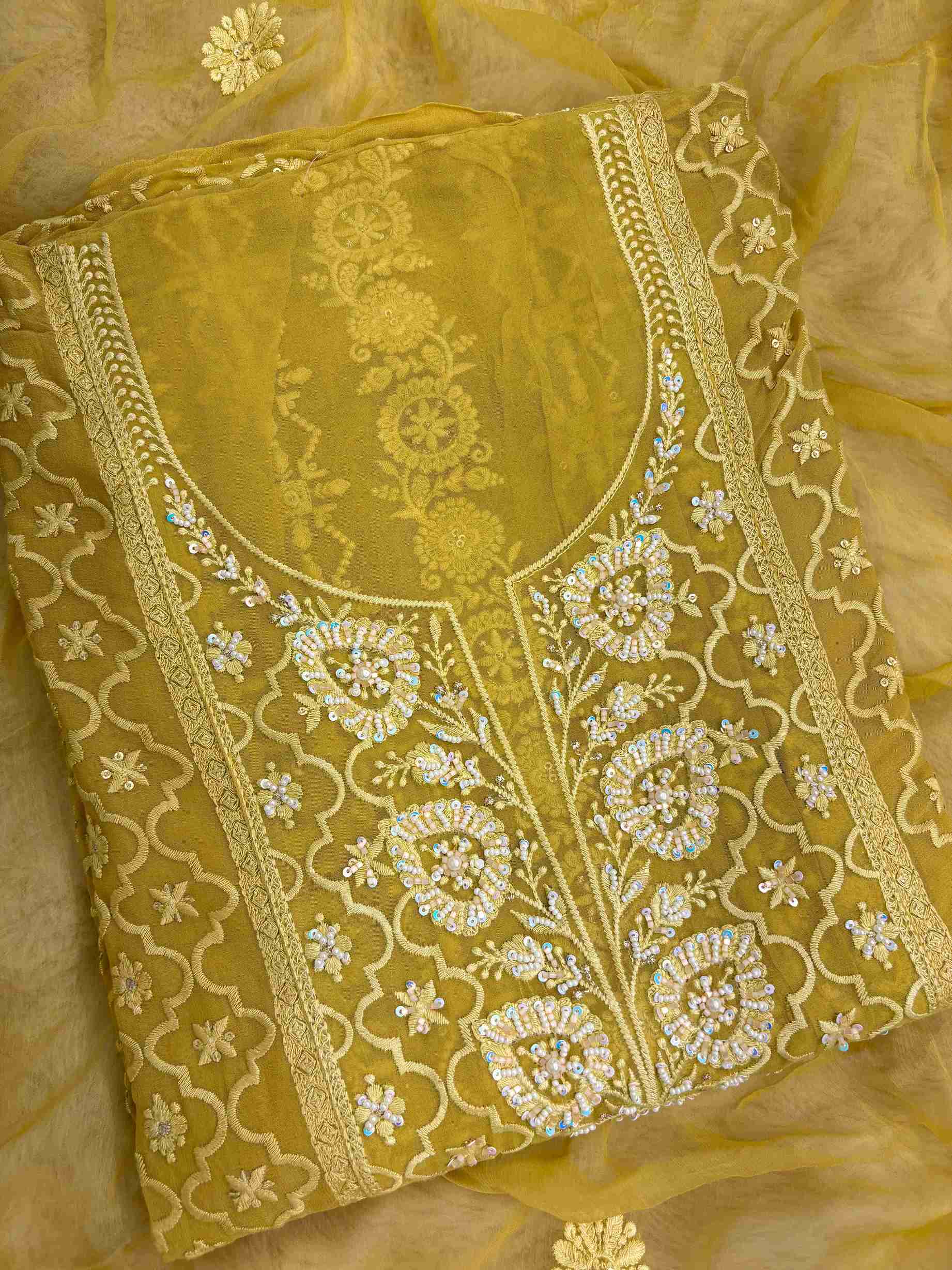 Mustard yellow suit neckline with moti beads and sequence embellishment