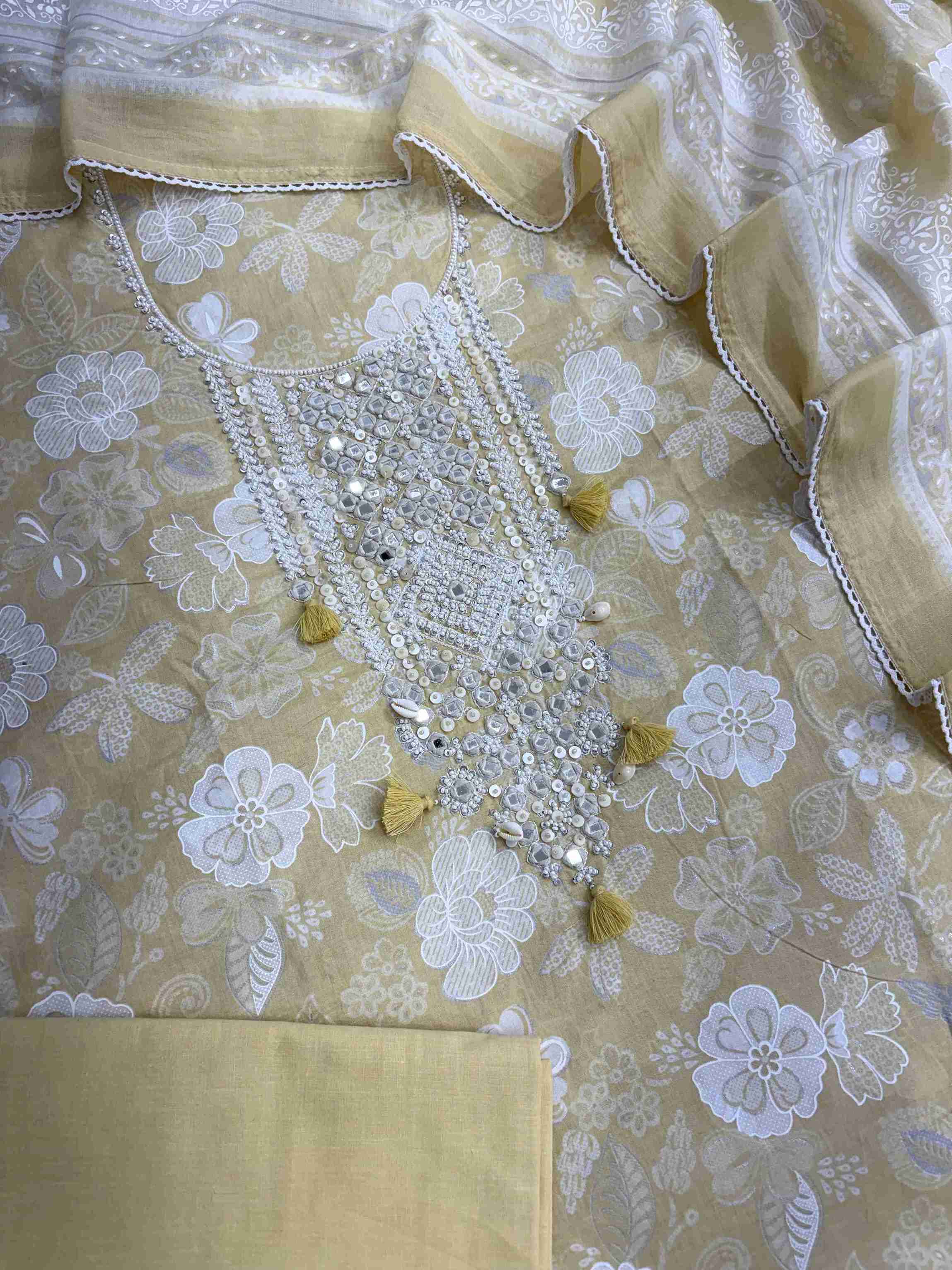 Complete yellow cotton unstitched suit flat lay set with floral printed shirt, dupatta, and matching cotton bottom