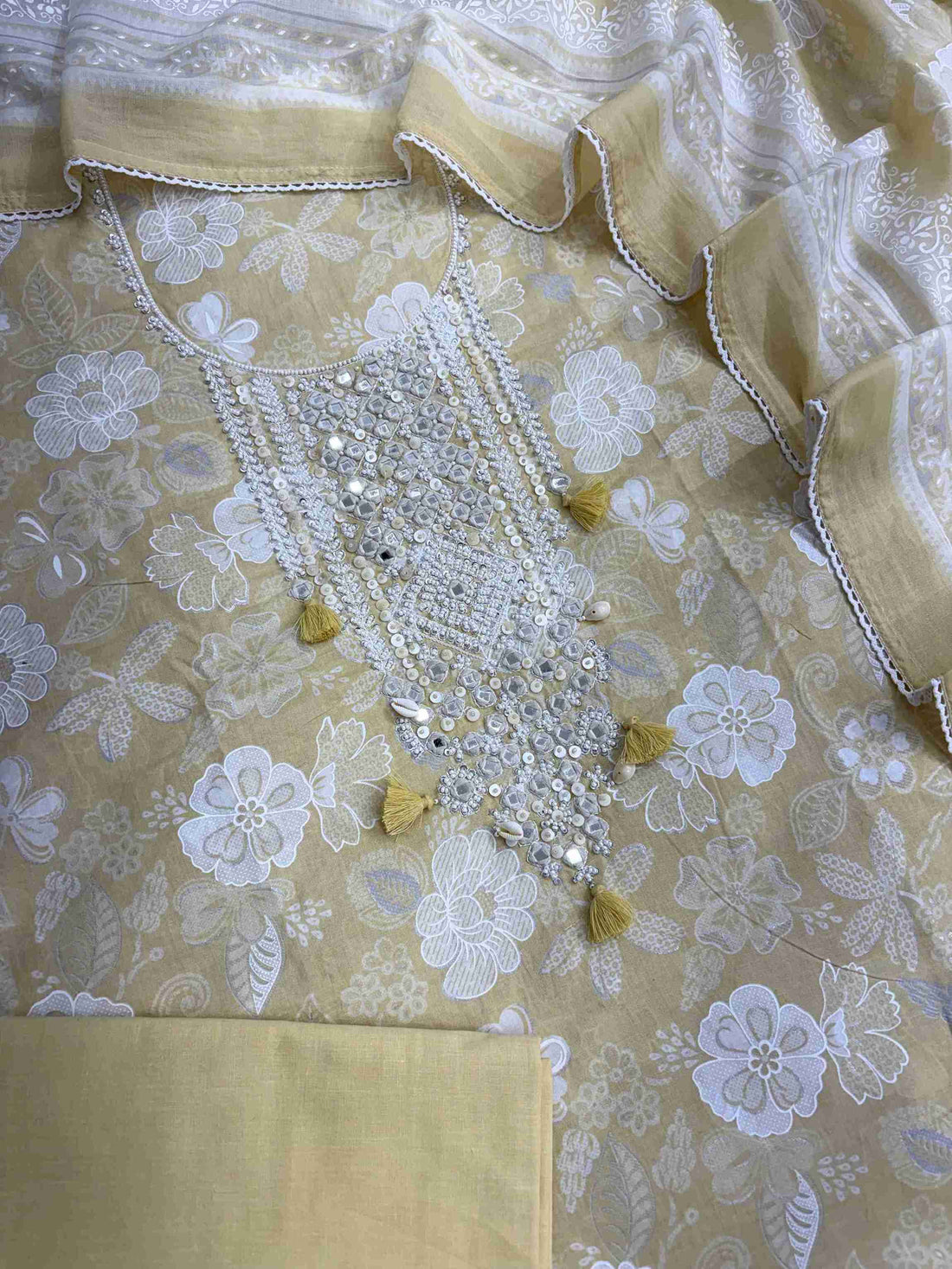 Complete yellow cotton unstitched suit flat lay set with floral printed shirt, dupatta, and matching cotton bottom