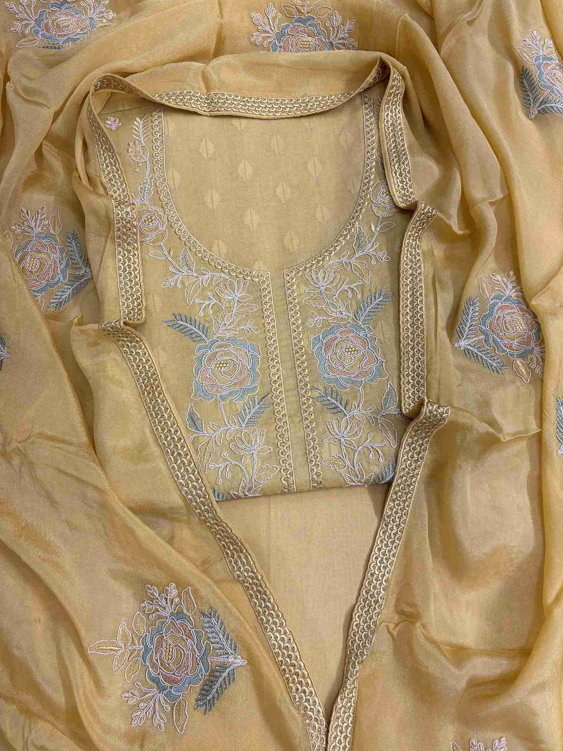 Mustard yellow cotton unstitched suit with floral embroidered neckline flatlay