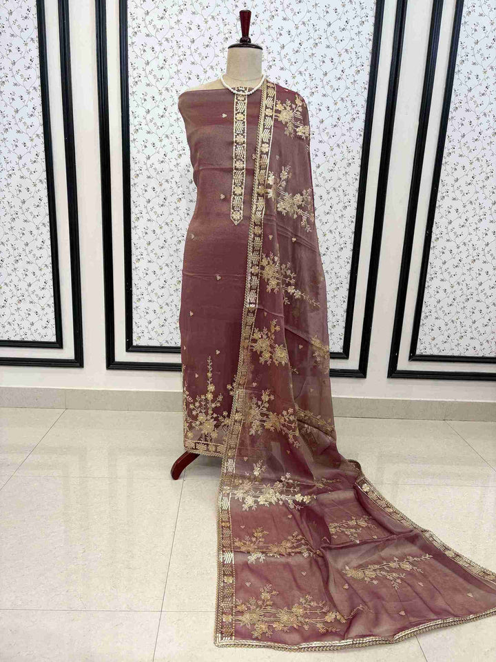 Muted mauve unstitched suit set with tissue shirt dupatta and opada silk bottom