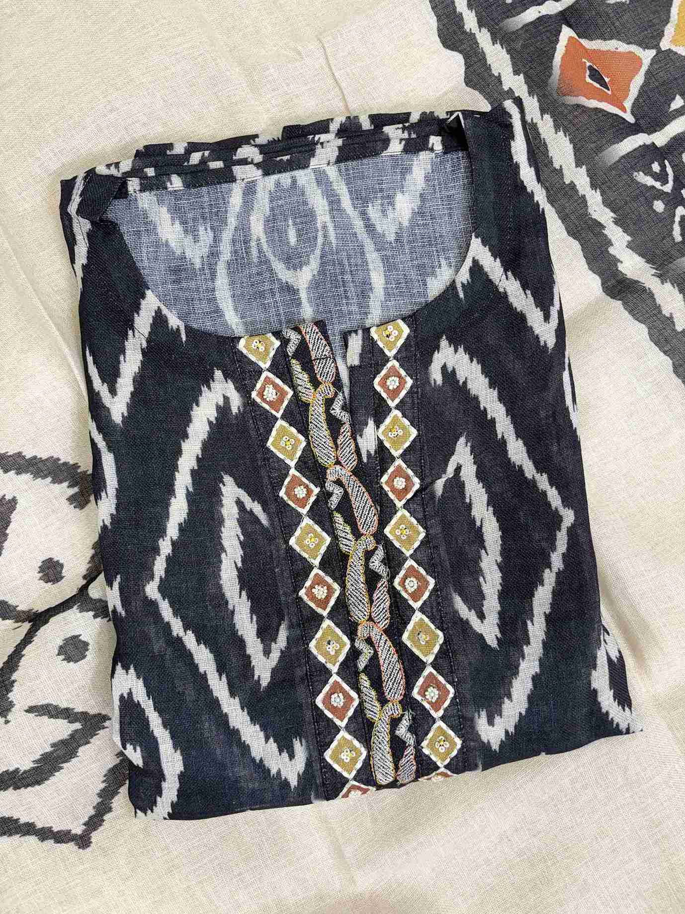 Embroidered neckline panel with multicolor thread and bead detailing on navy blue ikat linen shirt