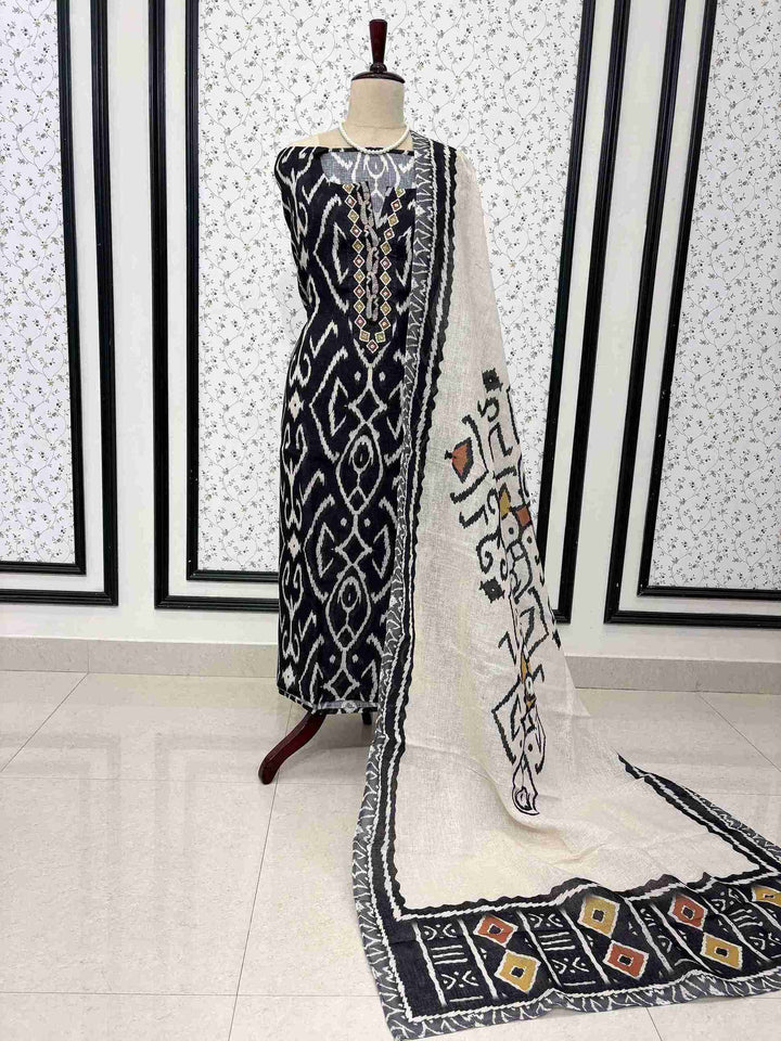 Navy blue linen unstitched suit full front view with off-white multicolor ikat print dupatta draped on mannequin