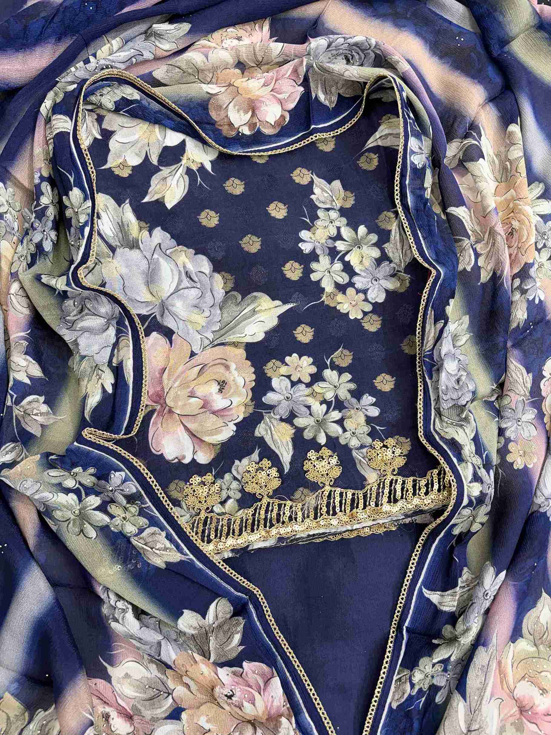 Close-up of all-over digital floral print in contrasting colors on navy blue muslin shirt