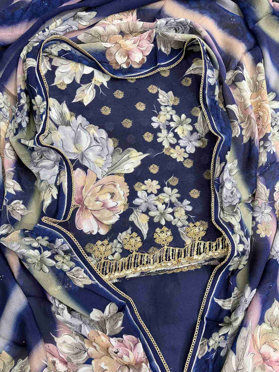 Close-up of all-over digital floral print in contrasting colors on navy blue muslin shirt